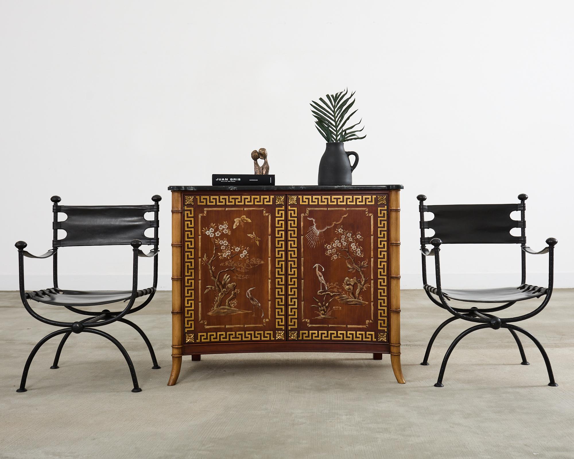 Amazing server cabinet or buffet designed by Mario Buatta for John Widdicomb. The cabinet is beautifully decorated in the Chinoiserie taste. The front of the cabinet is curved and has painted doors with idyllic Asian motifs bordered by Greek key