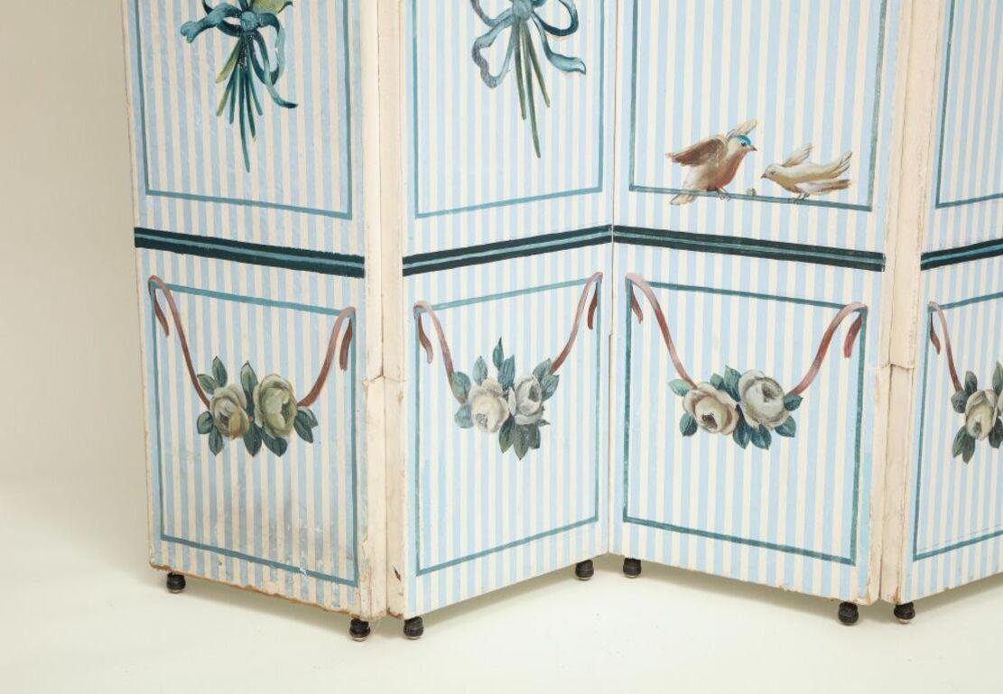 Each panel with arched top, painted with large ribbon-tied floral bouquets on a blue and white striped ground.