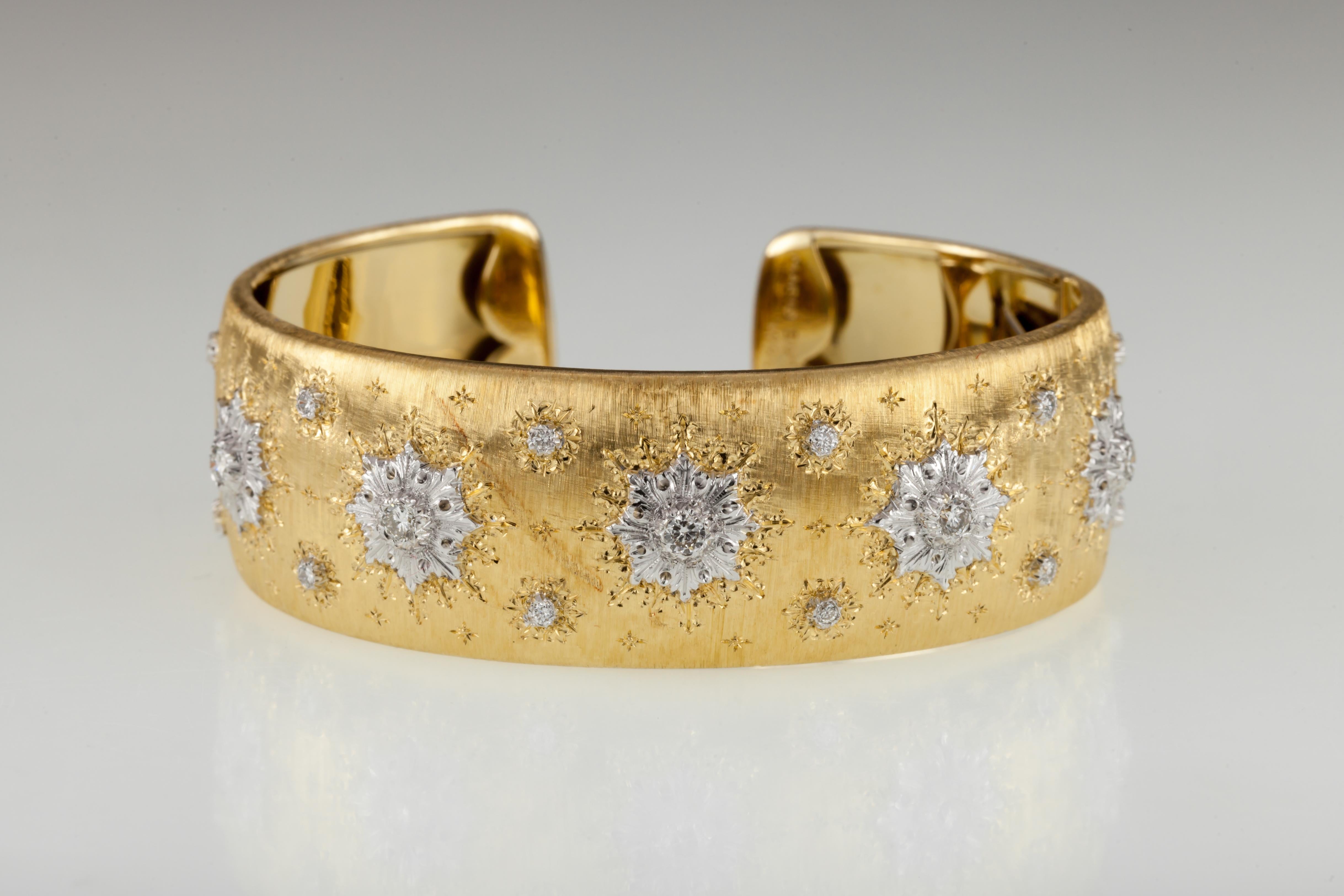 Beautiful Vintage Cuff Bracelet Designed by Mario Buccellati
Snowflake Motif
Brushed Gold Etched with Snowflake Patterns and set with round diamonds in White Gold Settings
Width of Cuff = Appx 20 mm
Inner Circumference (Wrist Fit) = 6.5