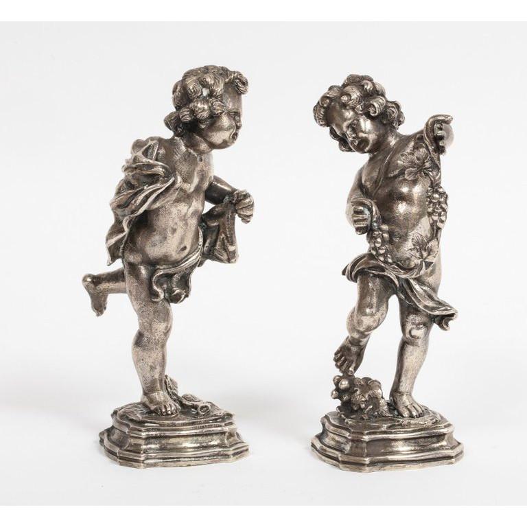 Mario Buccellati, a pair of Italian sterling silver figures of playful children / cherubs, (Table Ornaments),  circa 1970  Very good quality. Excellent condition.  Signed Buccellati and marked 800.  Measures: 5.5