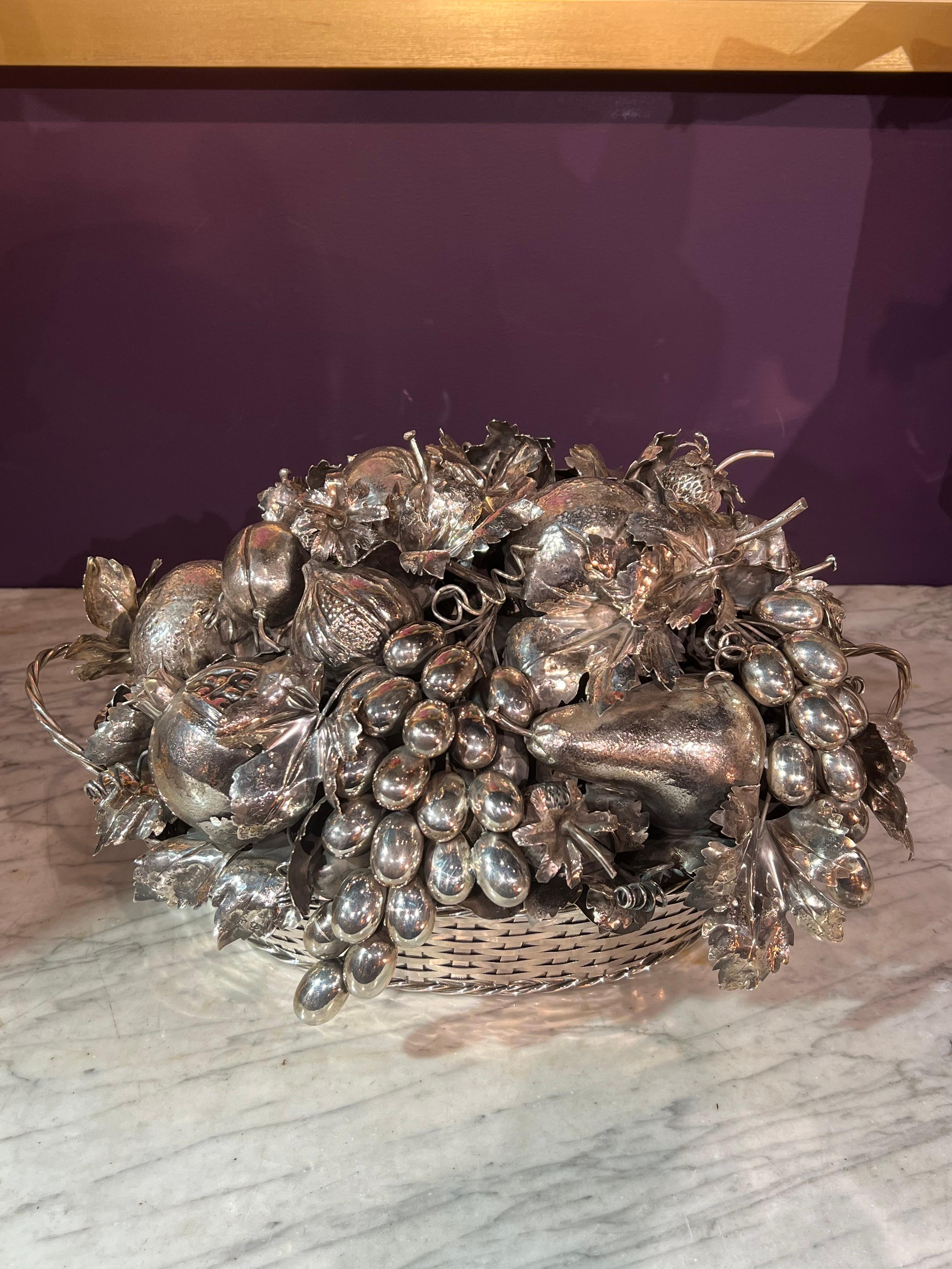 Mario Buccellati, An Italian Silver Fruit Basket Centerpiece and Bowl, Milan 20th century

The oval basket centerpiece is formed with woven bands, the lift-off cover is realistically a modeled as a group of fruits and leaves including grapes,