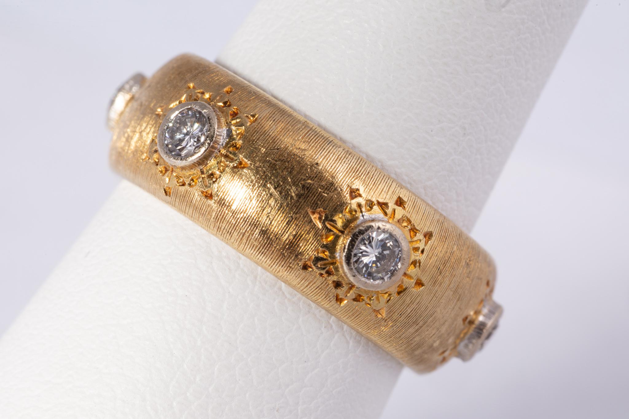 Beautiful Mario Buccellati band with 6 round brilliant cut diamonds weighing approx. .60cts total. The diamonds are E-F color and VS clarity. The ring is in the signature Florentine 18k yellow gold style with embellishments around the diamonds. The