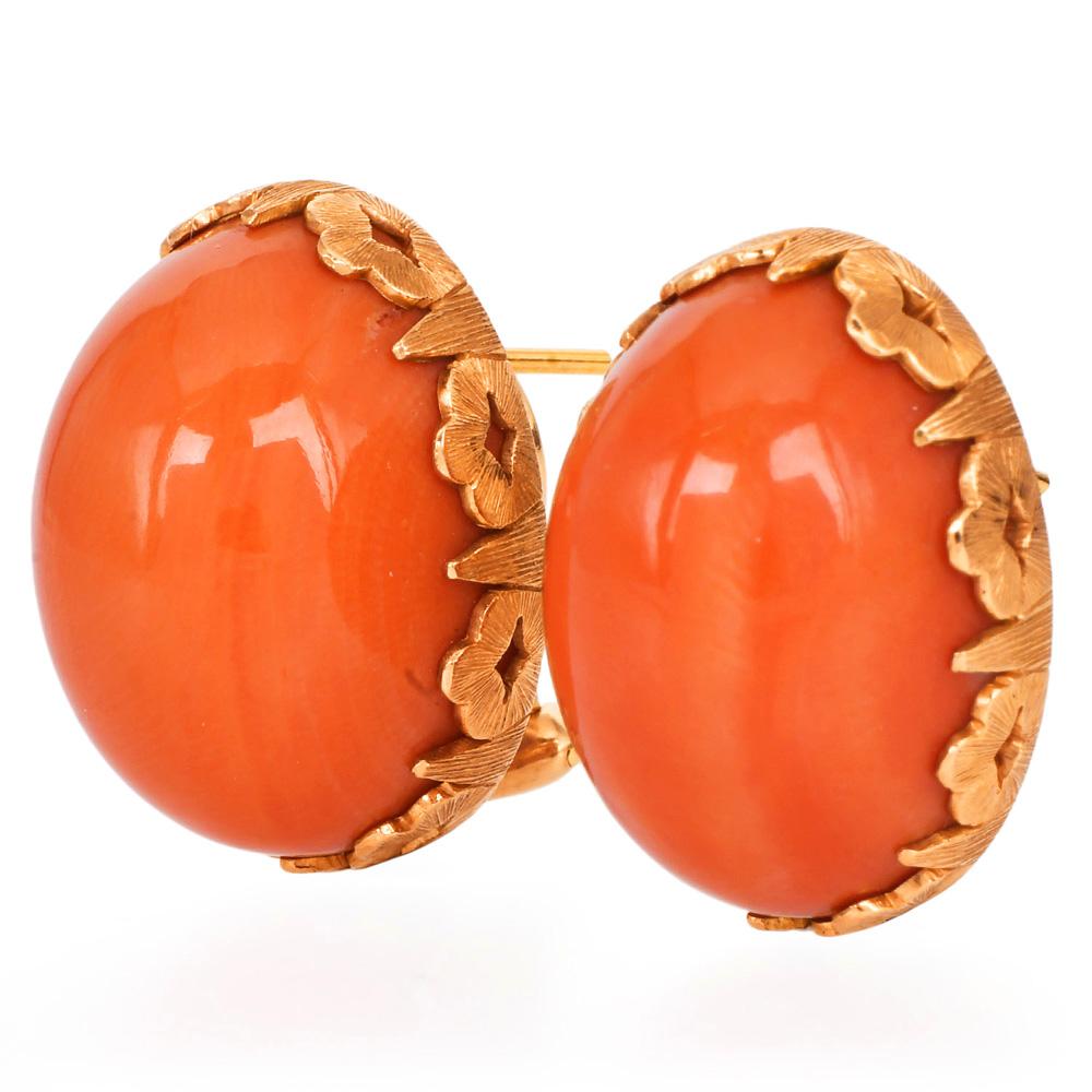 From the chic era of the 1960s with these striking oval statement earrings from the master Italian designer, Buccellati. 

Crafted in the finest 18-karat gold, these large oval earrings showcase the mesmerizing hue of natural Red coral, held