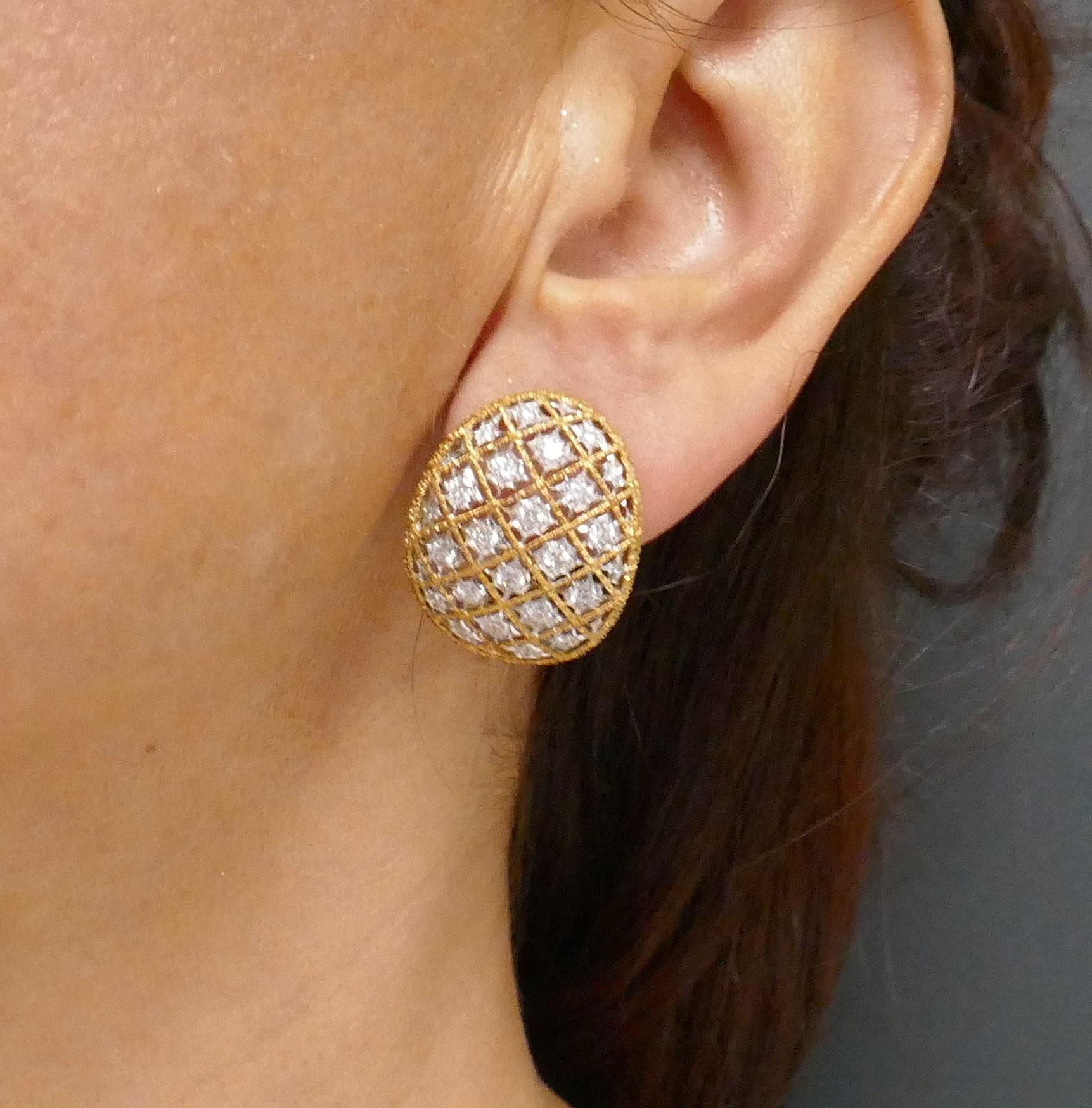 A pair of vintage Mario Buccellati diamond earrings, made in 18k white and yellow gold. These airy earrings are crafted from twisted gold wire that are part of an openwork design. The wire is crisscrossed inside an oval gold shape to create a