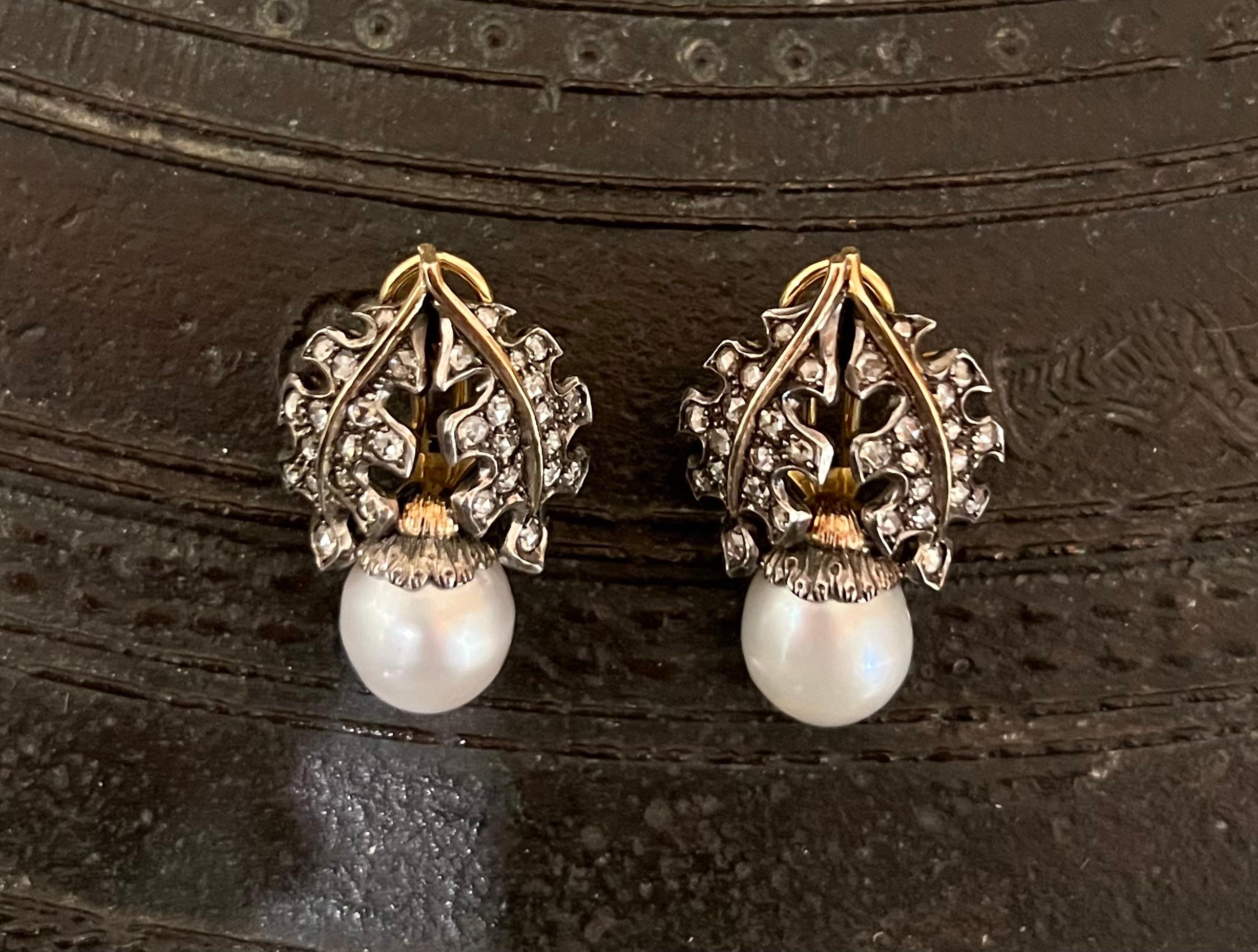 A pair of clip-on cultured pearls, rose cut diamonds (app. 1.15 cts), oxidized silver, and 18-karat gold earrings by Mario Buccellati, Italy. Signed M. Buccellati, 750, Italian Hallmarks. The earrings measure 1.27