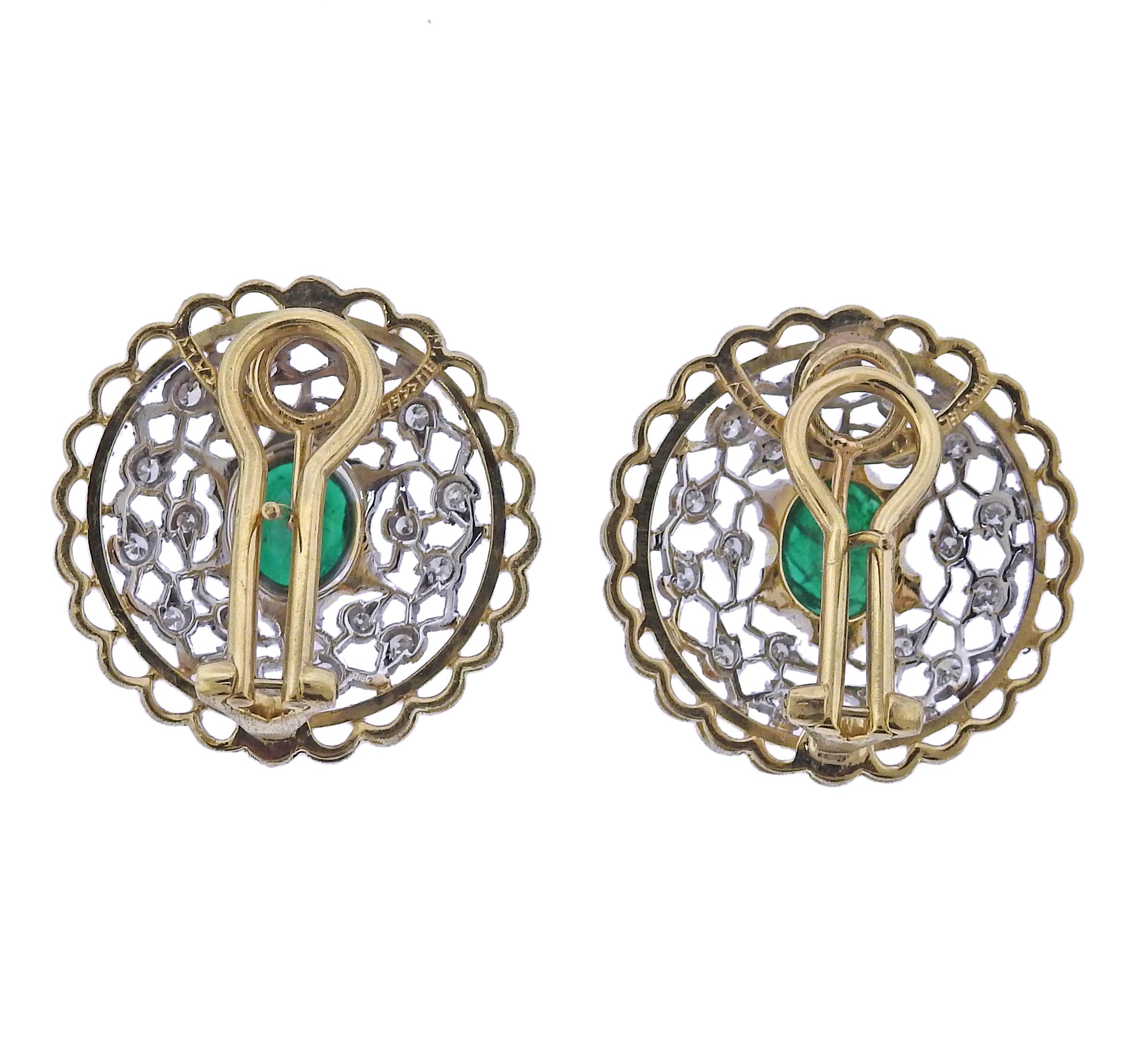 A pair of intricate 18k yellow and white gold earrings set with approx. 0.40ctw in diamonds and two emeralds approx. 1.66ctw.  Crafted by Mario Buccellati, the earrings measure 25mm in diameter and weigh 15 grams.