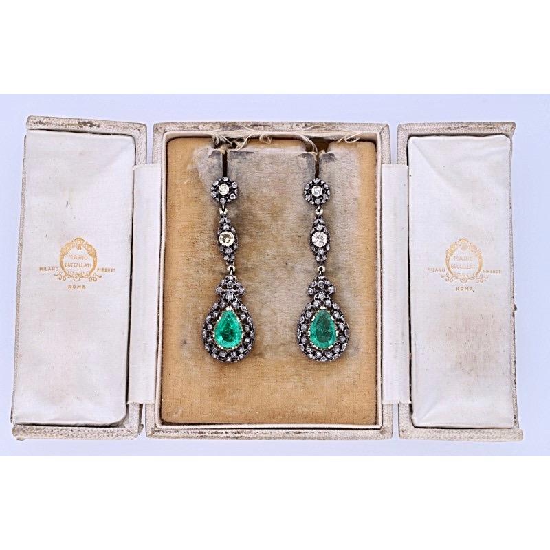 18 kt. gold and silver pair of earrings with 0.40 carat of round-cut light brown diamonds, circa 1.20 carat of diamonds rose-cut, circa 4.10 carat of Colombian drop-cut emeralds.
These elegant pair of earrings are completely hand-made and