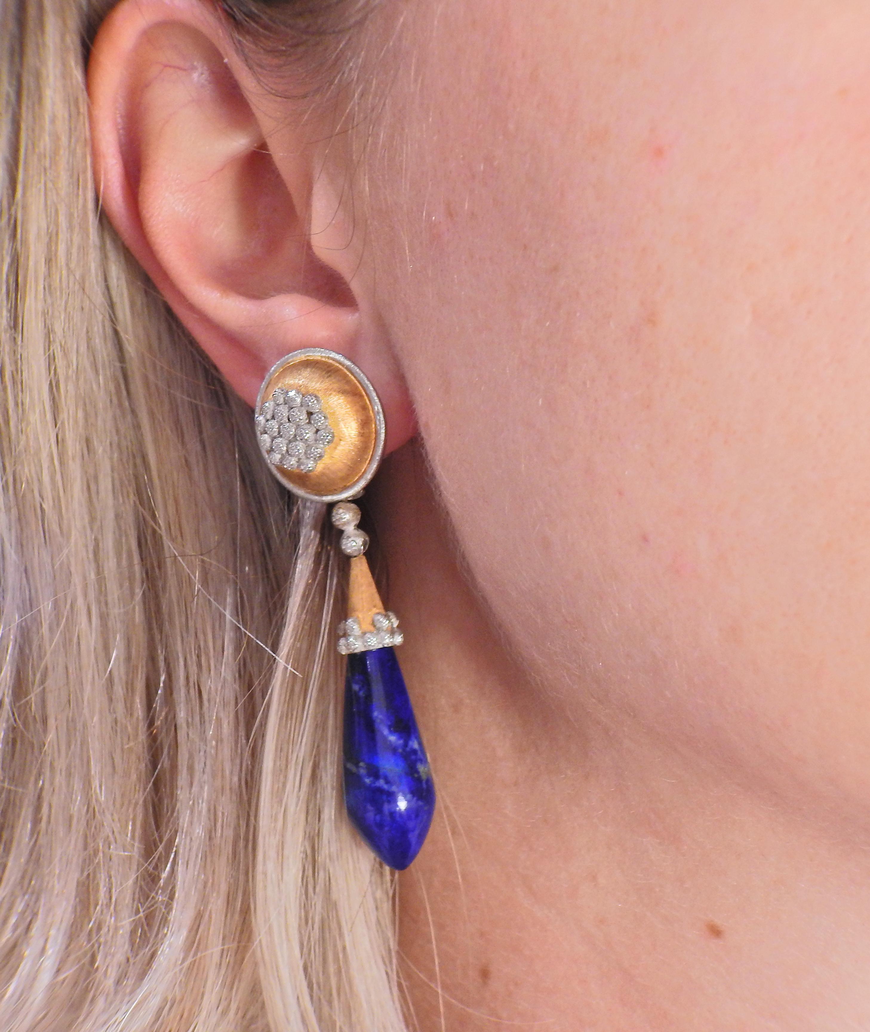 Pair of 18k white and yellow gold earrings by Mario Buccellati, with lapis lazuli drops. Earrings are 60mm long, top is 18mm in diameter. Marked: M. Buccellati, 750, Italian mark. Weight - 31.5 grams.