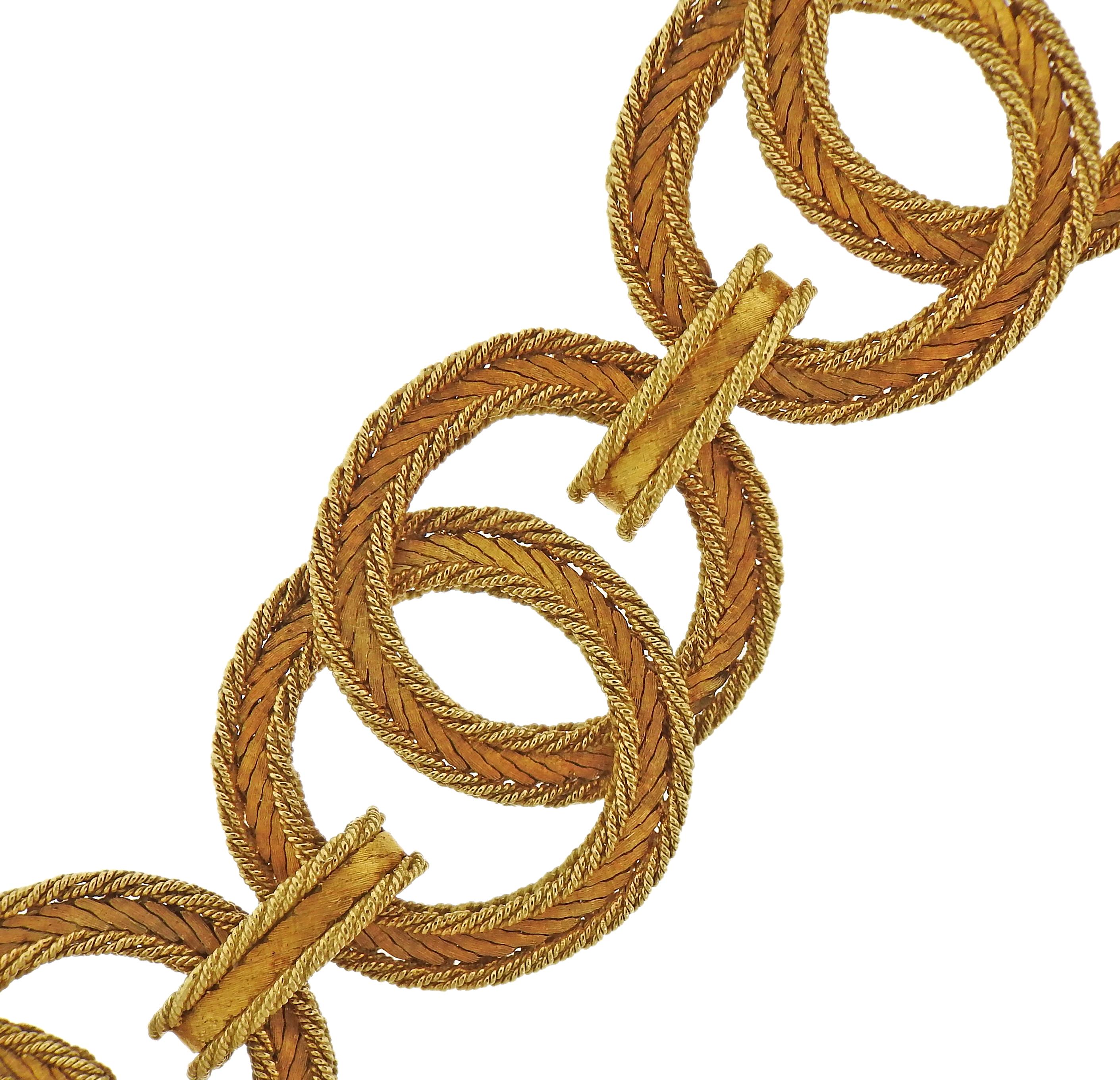 Large 18k yellow gold bracelet, featuring interlocked circle links in signature woven pattern, designer by Mario Buccellati. Bracelet is 7.75