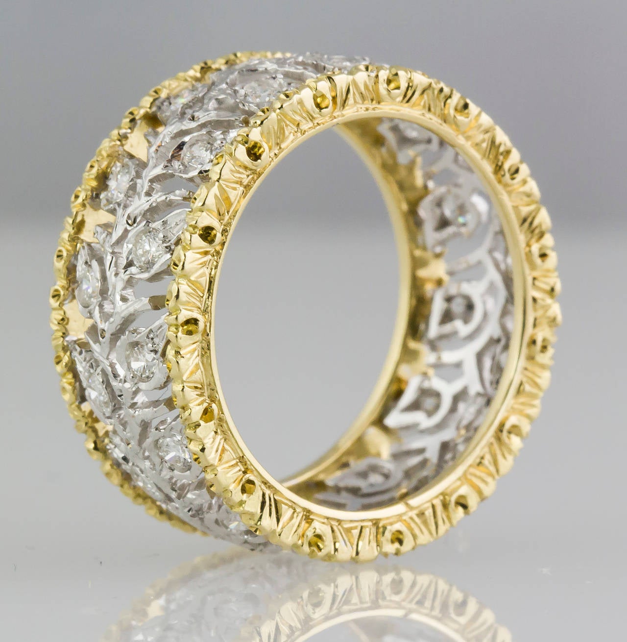 Fine  18K yellow and white gold diamond band ring by Mario Buccellati. It features a leaf motif with high grade round brilliant cut diamonds of approx. 1.00 cts. Size 6.5.  

Hallmarks: M. Buccellati, Italy, 750, Italian standard marks.