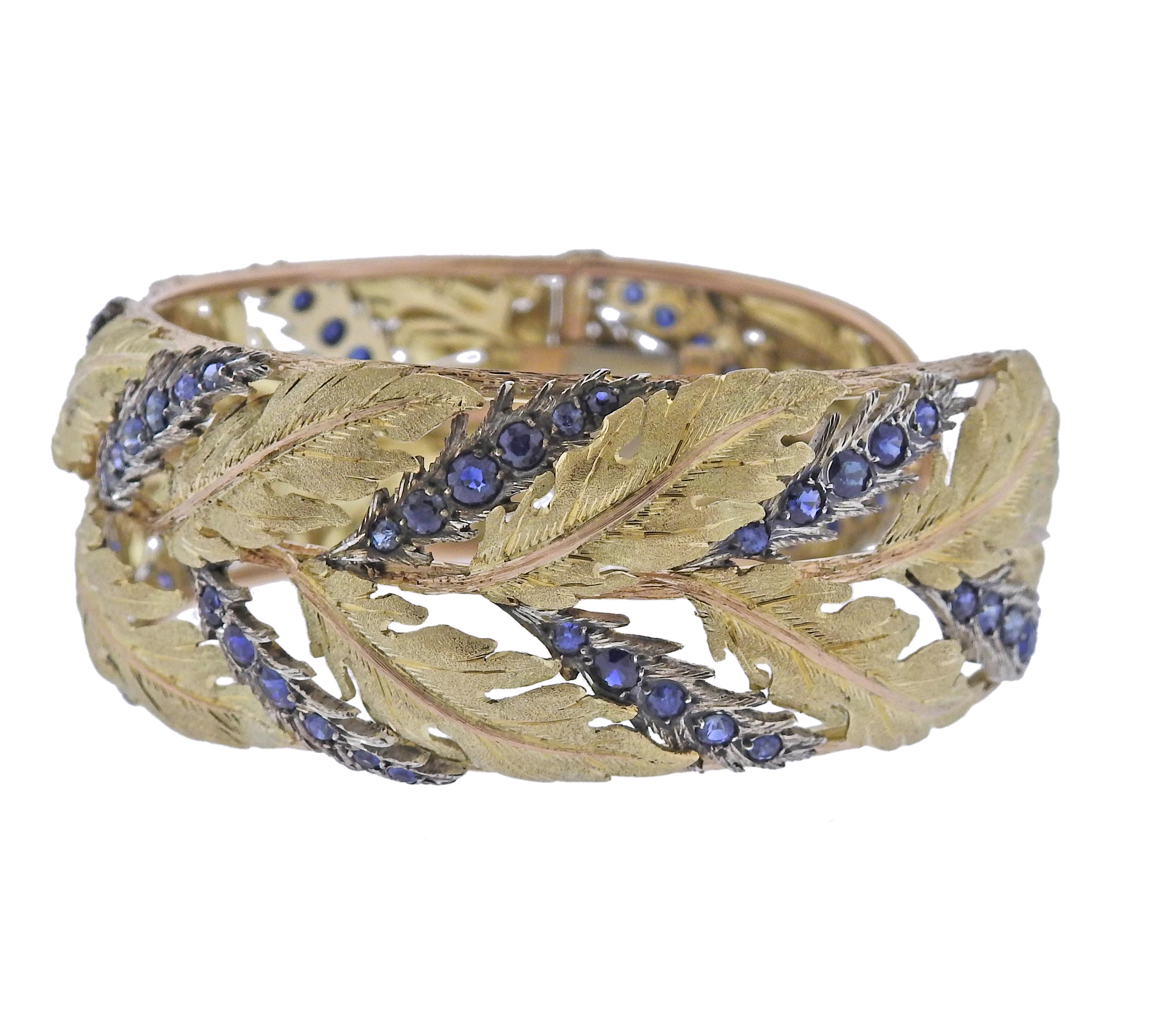 18k tri color gold leaf motif cuff bracelet by Mario Buccellati, adorned with blue sapphires. Bracelet will fit approx. 7