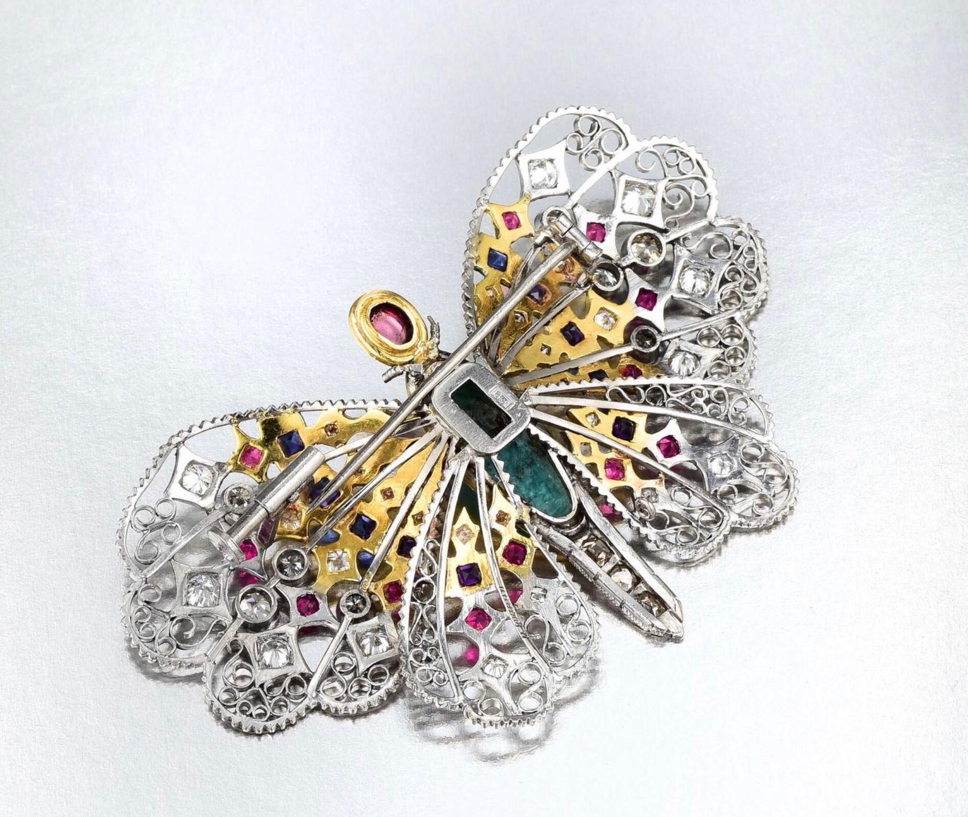 Crafted in 18K white and yellow gold, featuring a turquoise cabochon body; the wings enhanced by 12 round-cut rubies weighing approximately 0.60 carat, 10 square-cut sapphires weighing approximately 0.85 carat, 

36 single- and old European-cut
