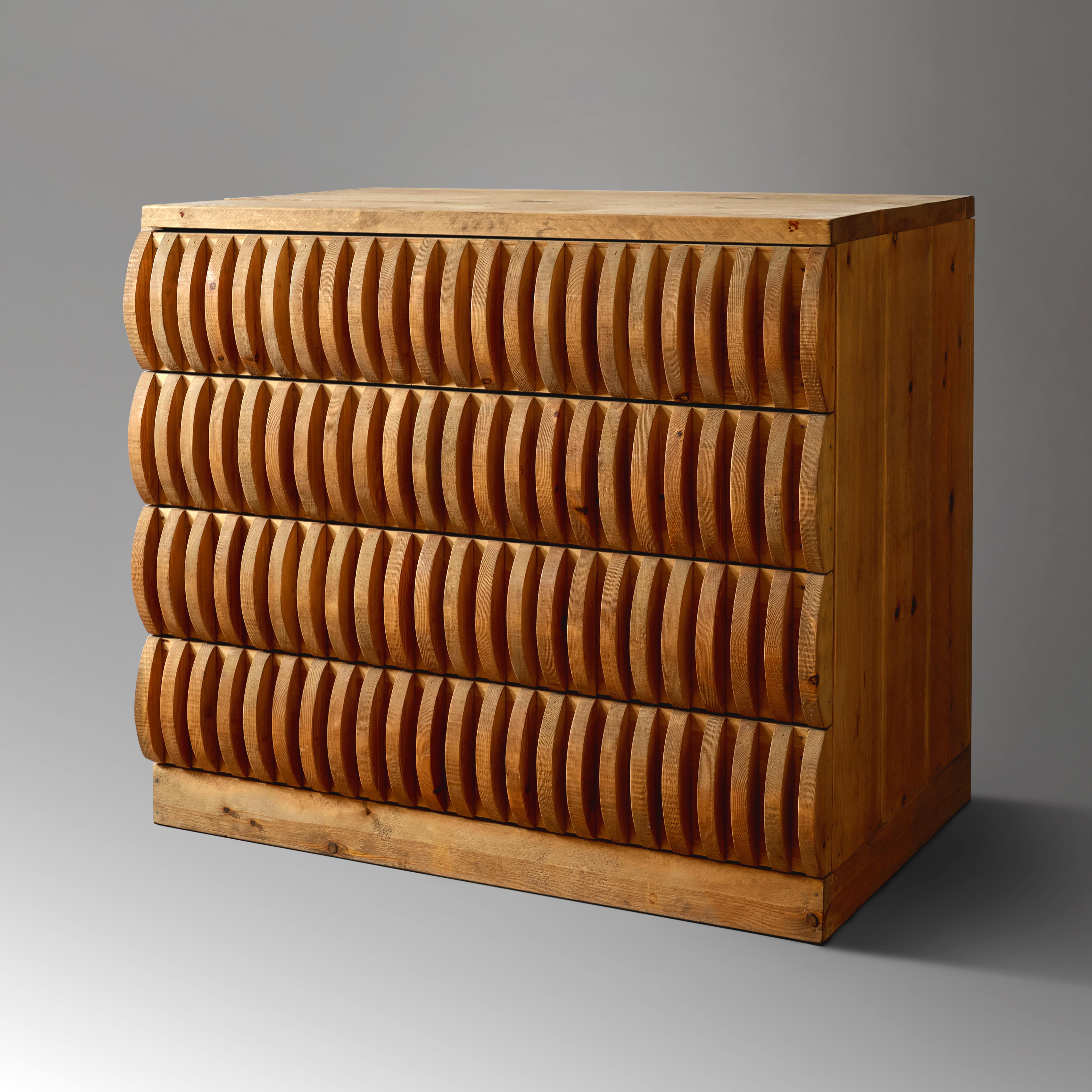 An exceptional, highly architectural chest of drawers constructed of solid, untreated Russian pine, with each of the four drawer fronts fitted with a repeating series of semicircular elements, designed by acclaimed Italian post-war artist and