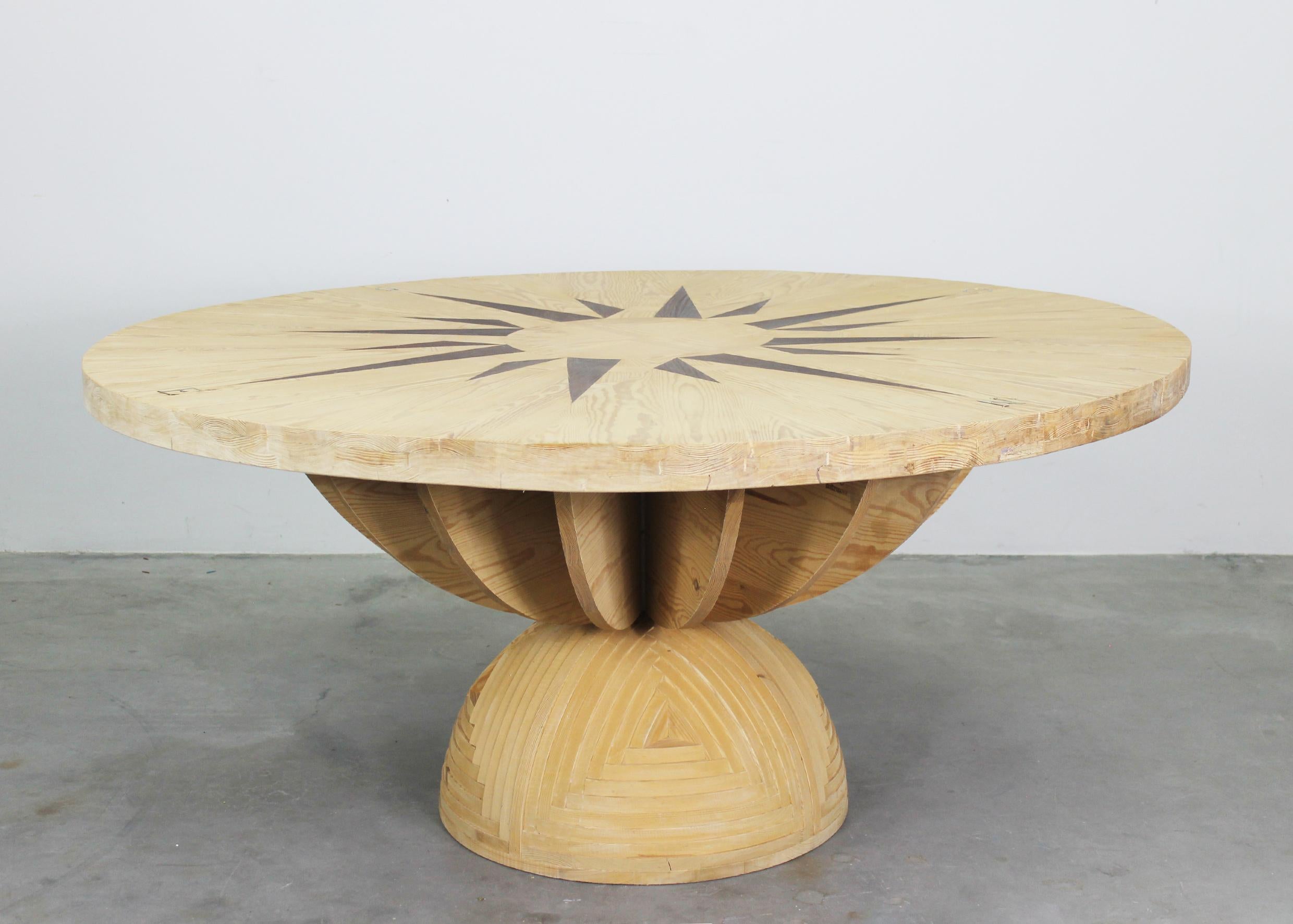 Round table model La Rosa dei Venti, part of the Mobili nella Valle series, it's entirely realized in pinewood, with inlays on table-top, it was designed by Mario Ceroli and produced by Poltronova in the 1970s.

The beautiful inlays on the table top