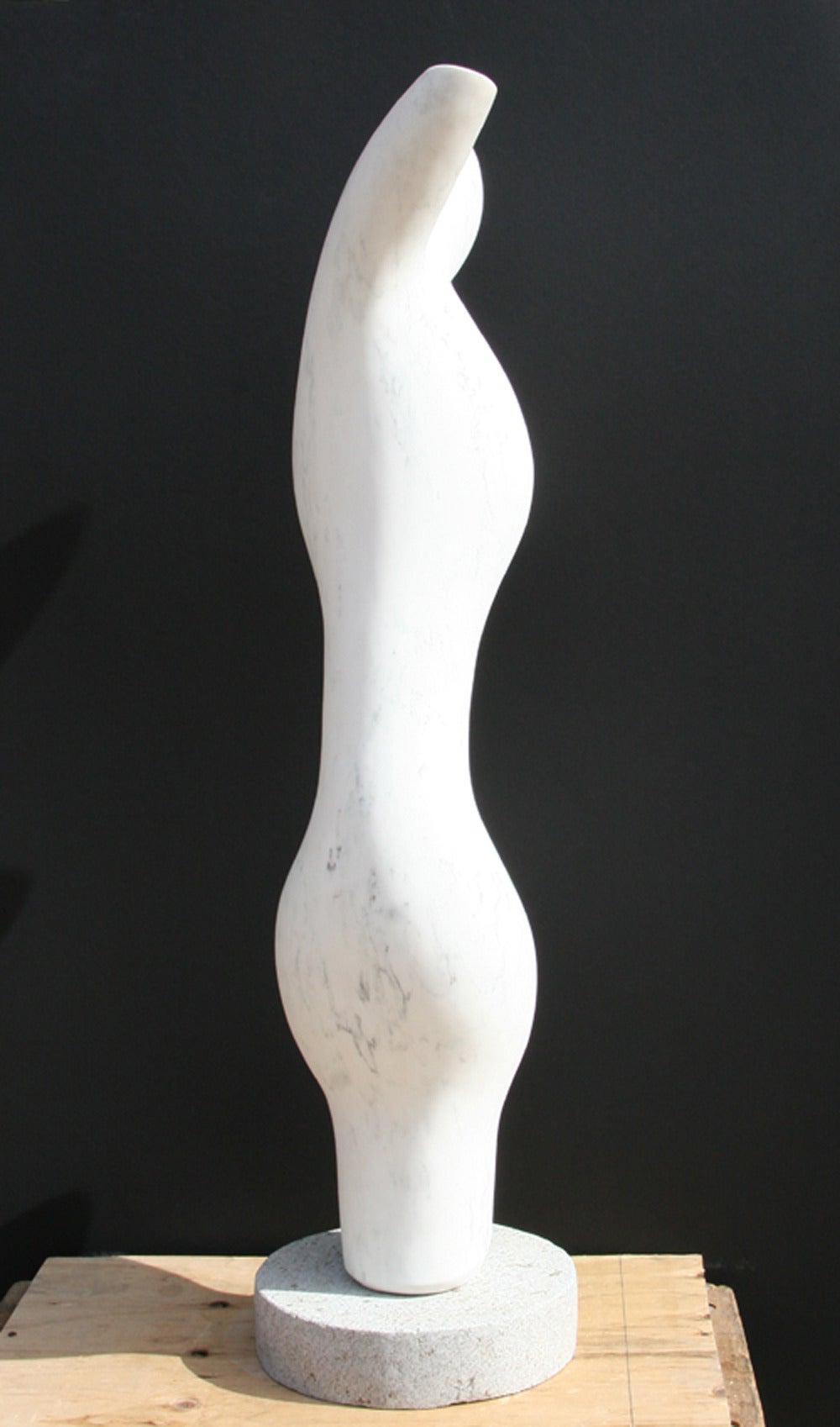 A white marble sculpture by Mario DeNoto. A modern abstract figure of subtly human-like features and slight gray veining. 
 
Artist: Mario DeNoto
Title:	Abstract Figure
Medium:	White Marble Sculpture on a Granite Base
Size: 46 x14 x 10 inches