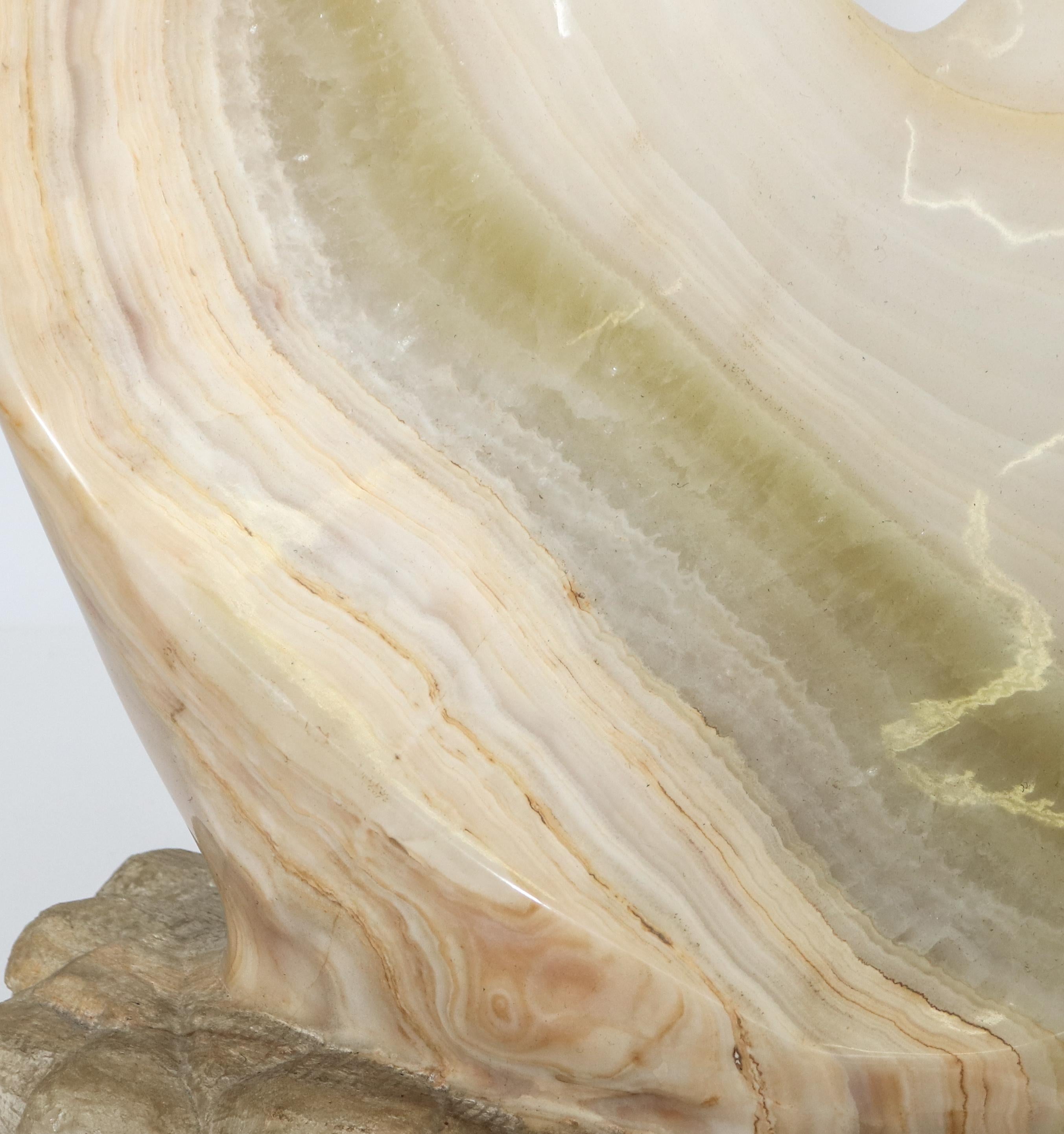 Mid-Century Modern carved white onyx biomorphic sculpture consisting of polished coiled form with raw base, etched signature and date 