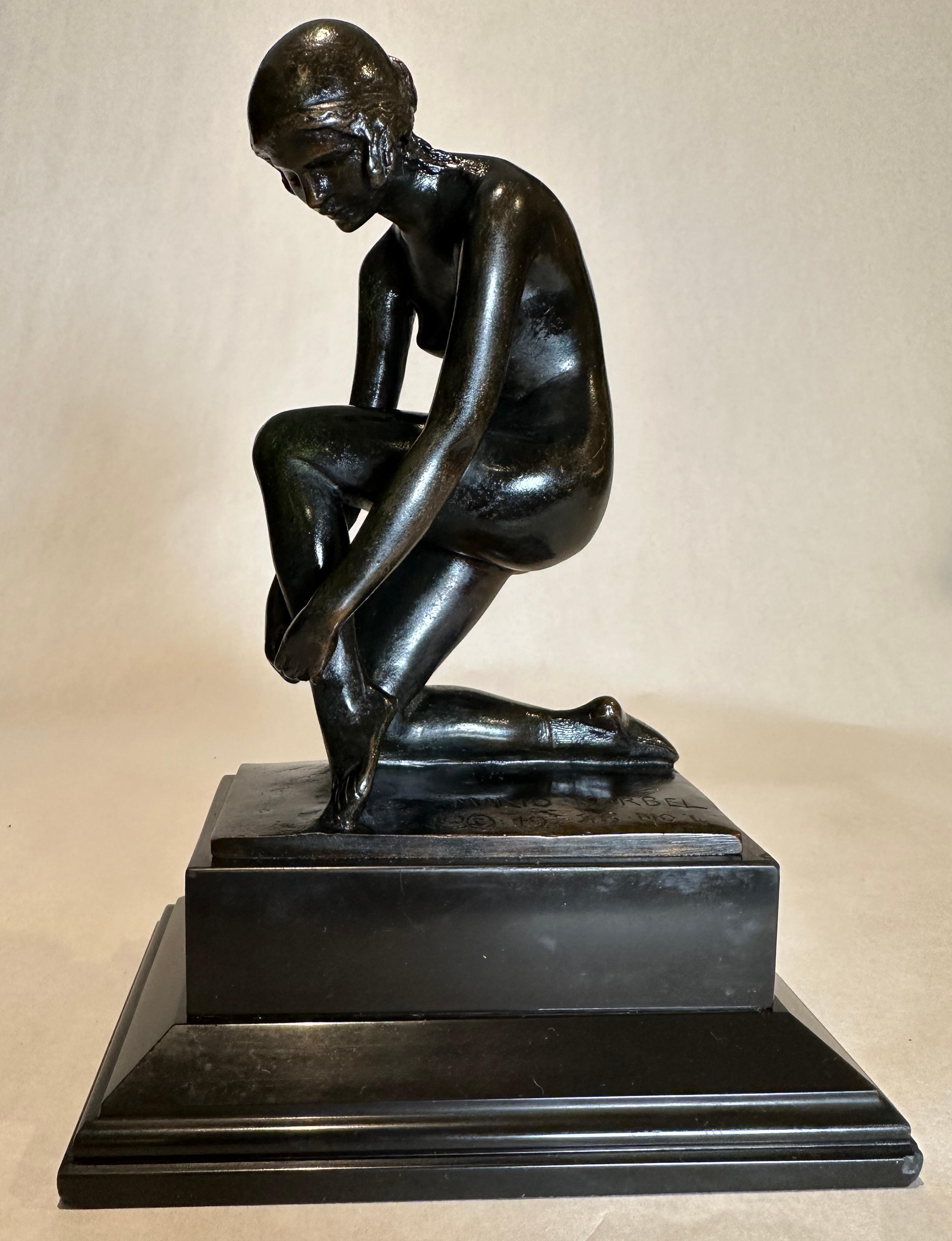 Joseph Mario Korbel (Czech/American, 1882-1954). Period fine example bronze, dark brown patina, modeled as a nude female kneeling and tying her sandal, raised on a stepped black marble base, signed Mario Korbel/ 1926 No. 4, and stamped 'Roman Bronze