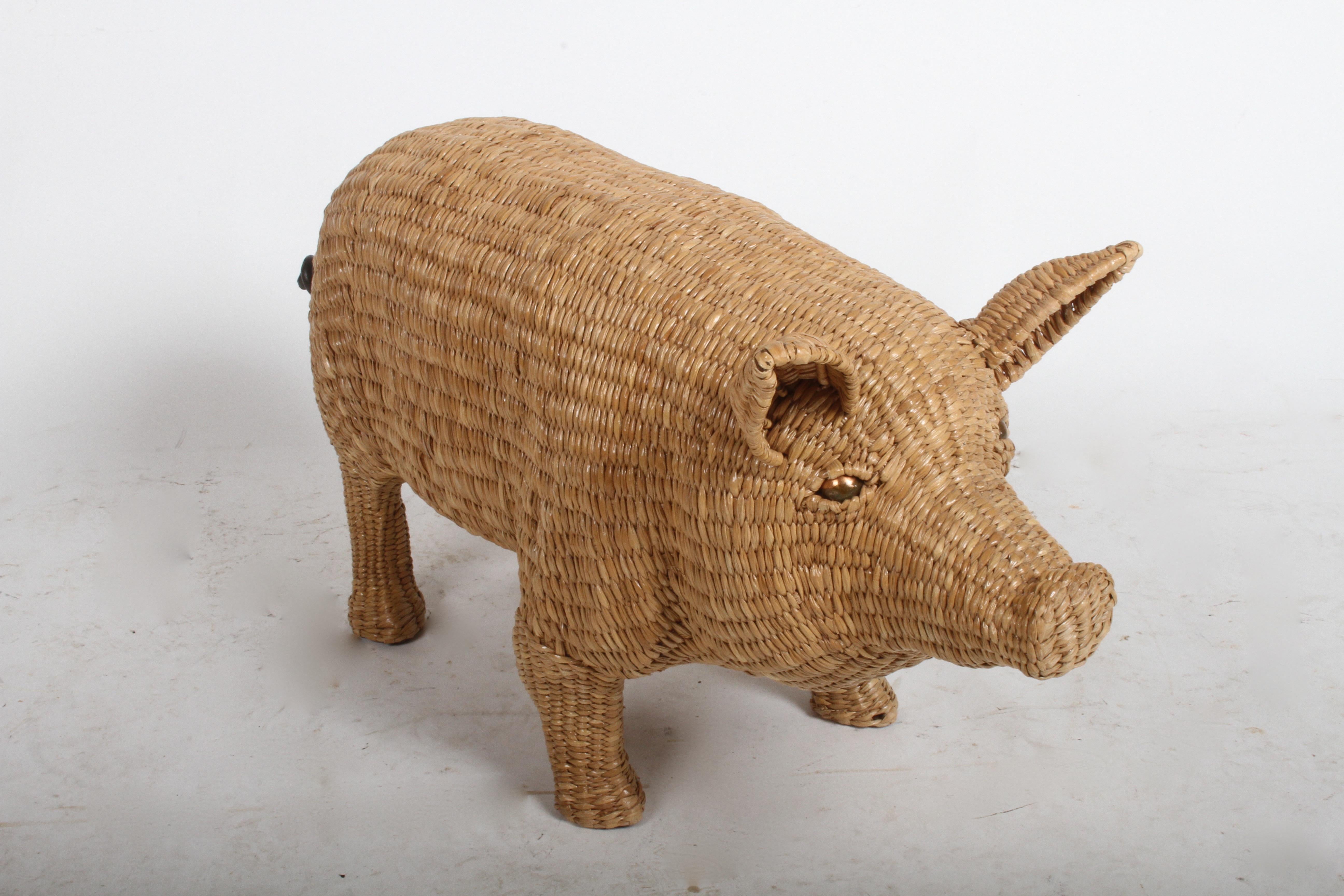 Rarely seen and highly sought after Mario Lopez Torres wicker pig sculpture. Wicker woven over iron frame, copper eyes and iron tail. Signed and dated on a brass medallion found on the underside chest of the pig: Mario Lopez Torres, Tzumindi, Hecho