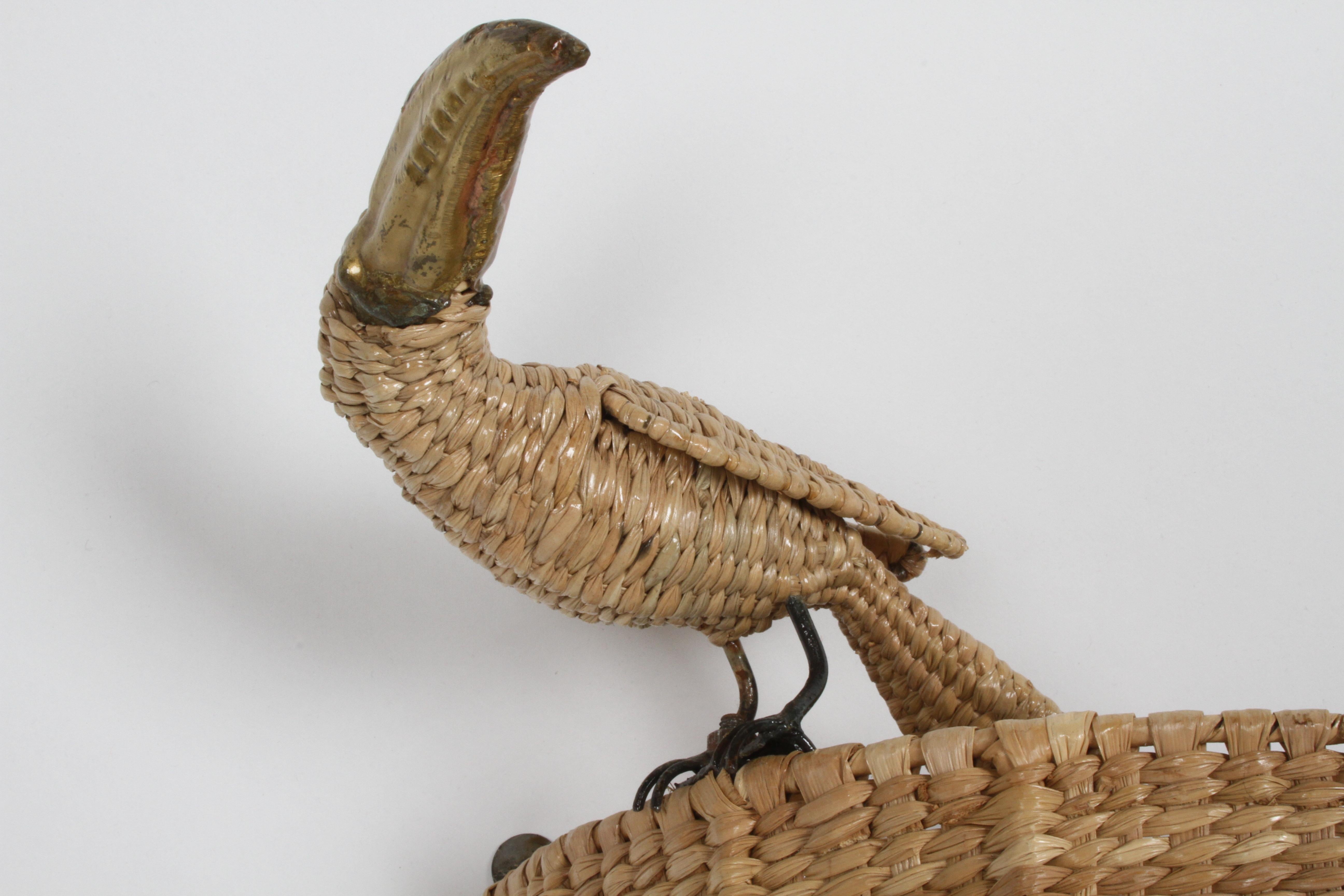 Mario Lopez Torres whimsical wicker Toucan with brass beak wall sconce light. Retains brass medallion on inside : signed Mario Lopez Torres, Tzumindi, Hecho en Mexico, 1974. Includes threaded metal rod to attach light socket and cord, should you