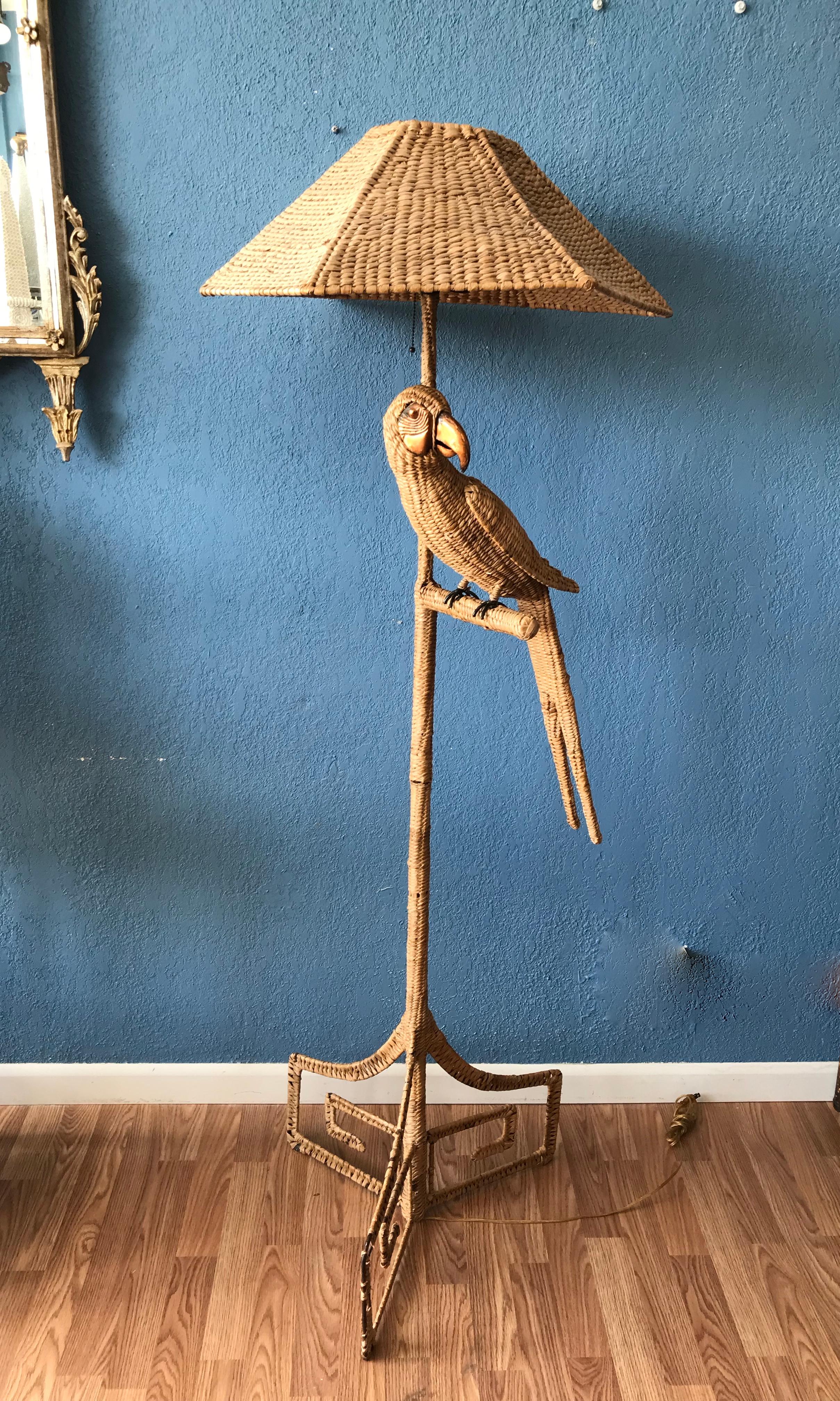 Whimsical wicker/reed parrot floor lamp with a brass and copper beak and face. 
The wicker shade is original.