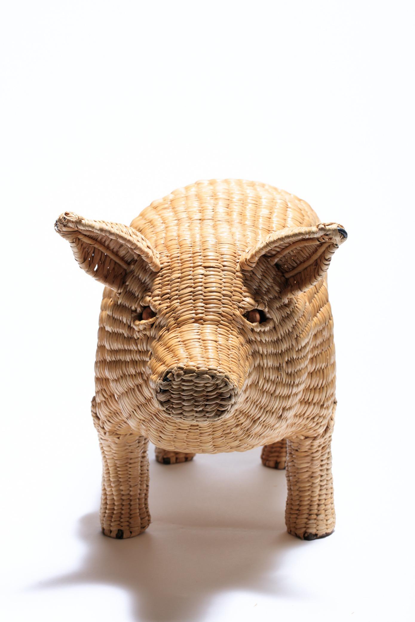 Fun Mario Lopez Torres wicker pig sculpture, Mexico 1970s. The pig features an iron frame with wicker woven over the frame and finished with copper eyes and an iron tail. Brass medallion on the underside includes the artist's name and reads 