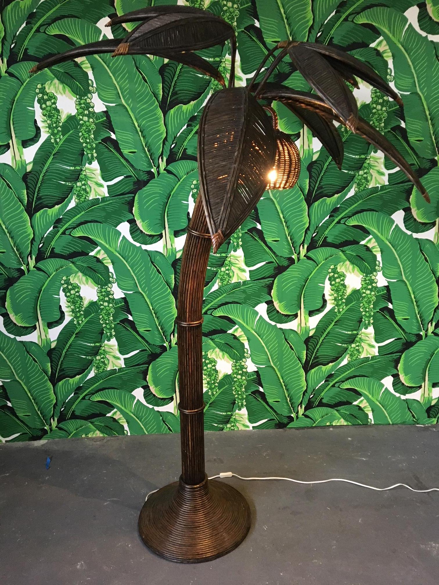 Sculptural rattan palm tree floor lamp in the style of Mario Lopez Torres, circa 1970s. Very good condition. In-line power switch and three bulbs. Palm fronds can be removed and adjusted into different positions.