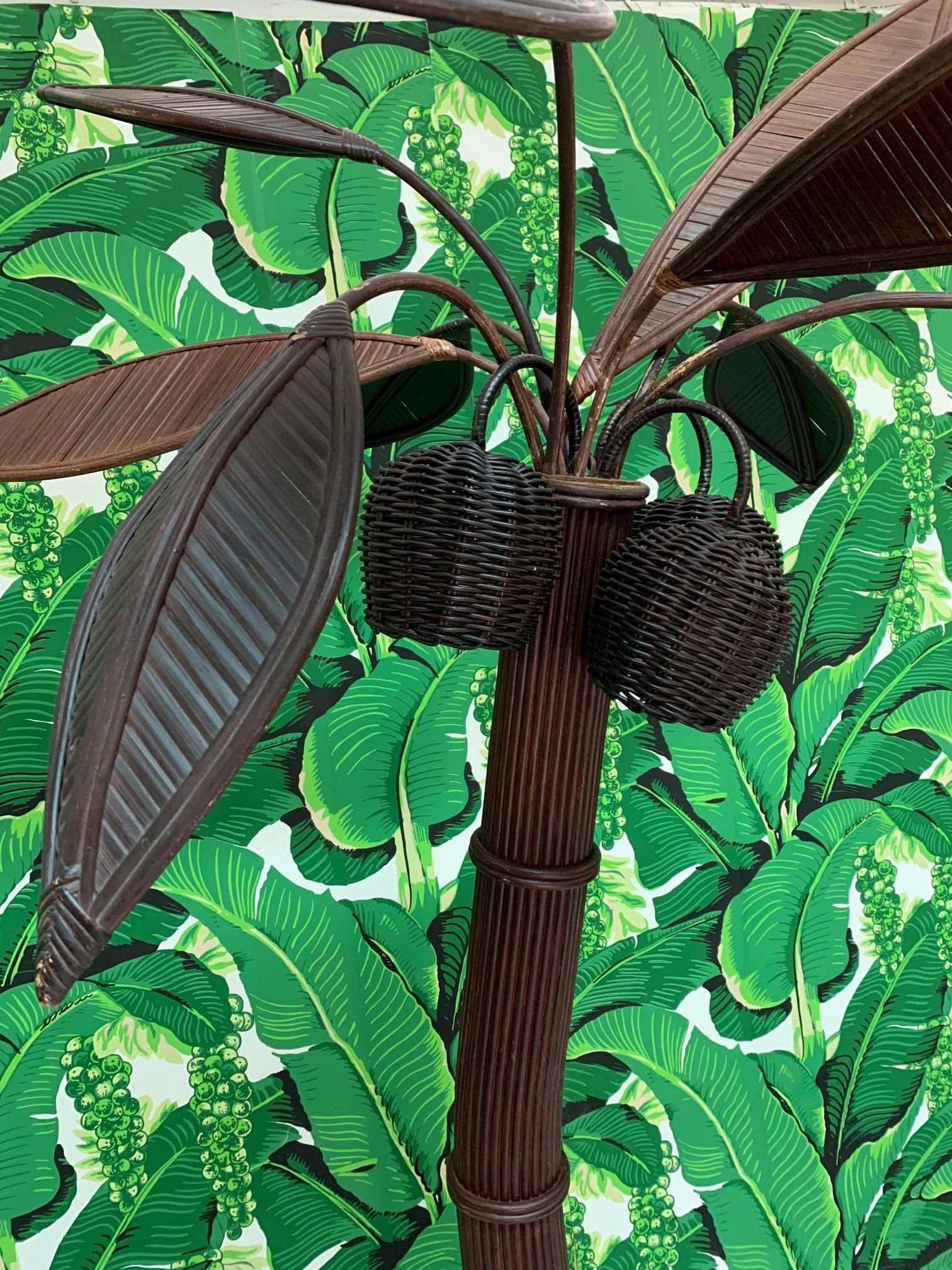 Sculptural rattan palm tree floor lamp in the manner Mario Lopez Torres, circa 1970s. In-line power switch and three bulbs. Palm fronds can be removed and adjusted into different positions. Measures: Stands approximate 84
