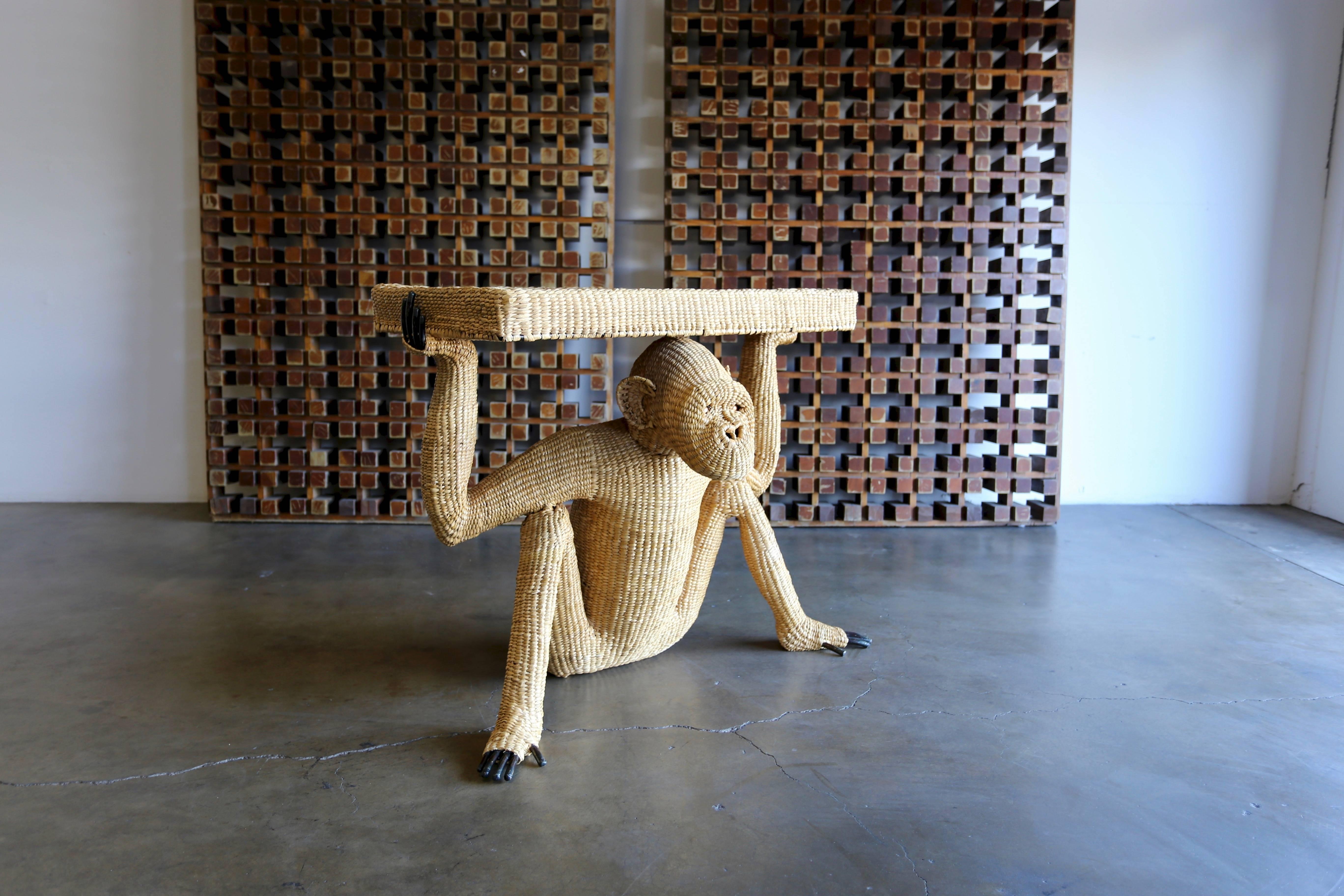 Mario Lopez Torres woven reed and copper console table. Sculptural console in the form of a Monkey or Chimpanzee. This piece is signed with a Mario Lopez Torres medallion. Very good original condition. 

The table top measures: 35