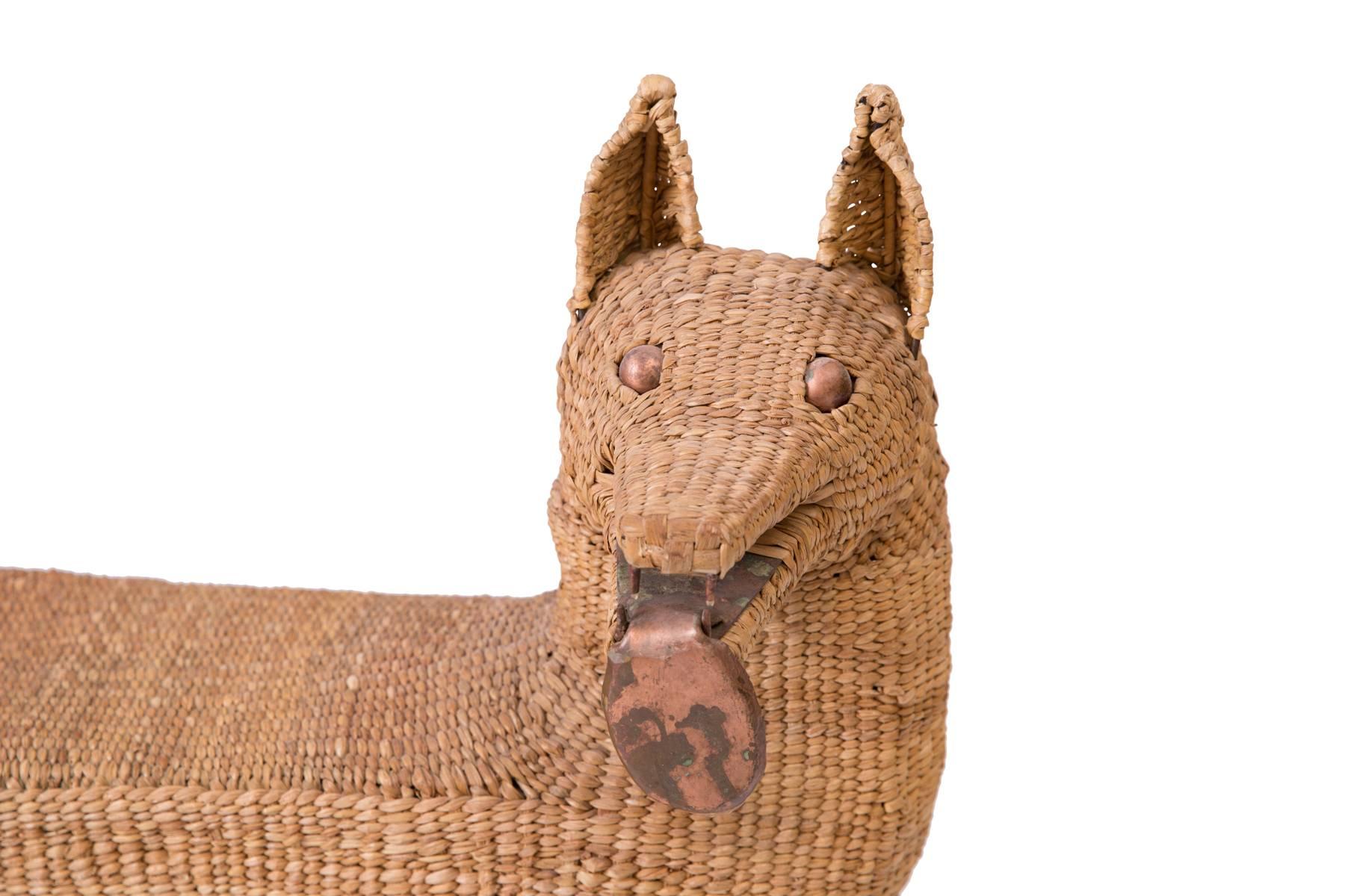 Mario Lopez Torres woven reed and copper dog bench or sculpture. This example utilizes reeds picked from the marshes of Ihuatzio Mexico that are then dried and carefully wrapped around iron forms. The ears, eyes and tongue are patinated copper.