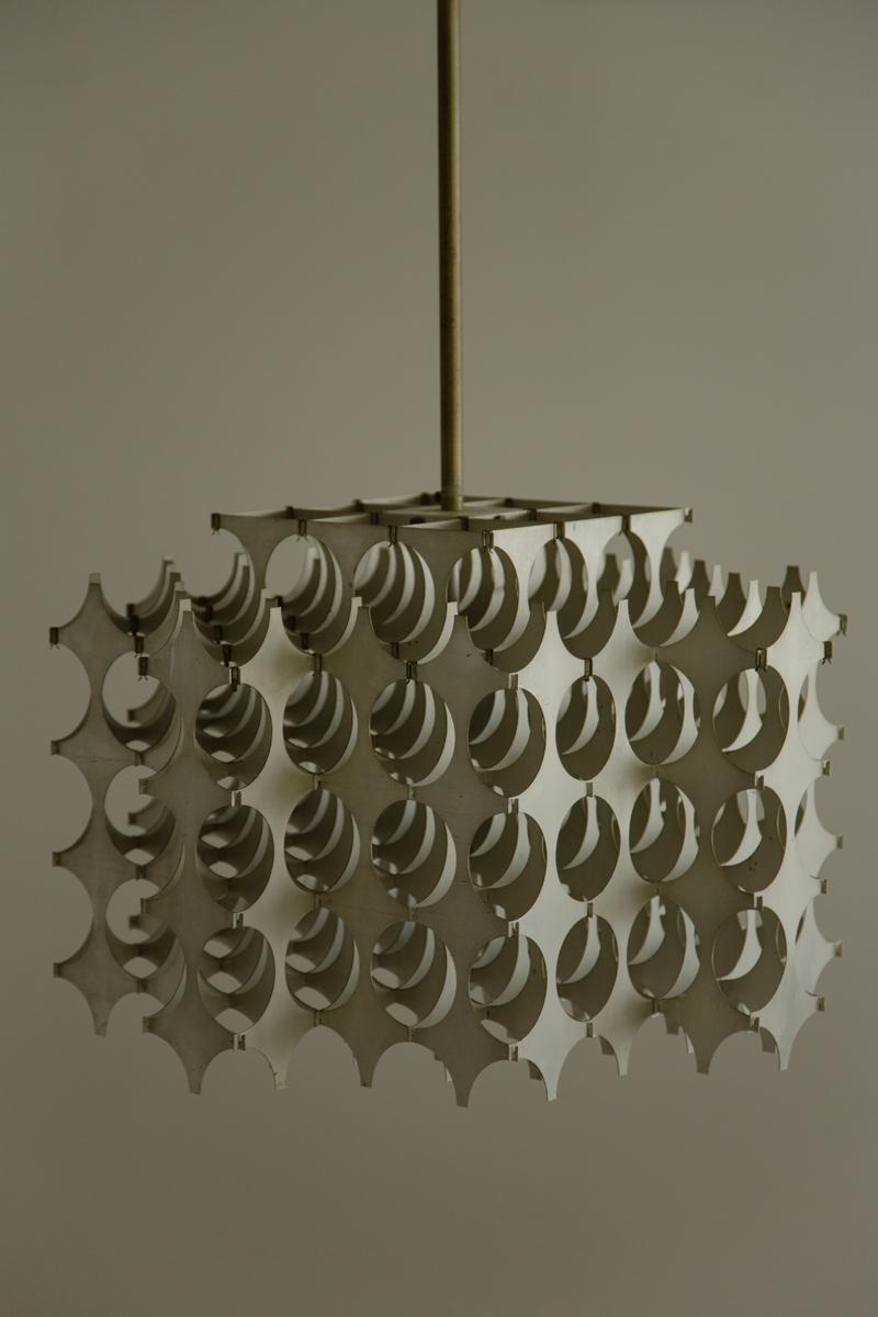 Chandelier by Italian designer Mario Marenco for Artemide, 1968. The piece is named ‘Cynthia’ and has an elegant and kinetic design which varies depending on the angle of the viewer. Featuring cut aluminium panels slotted together to create a cuboid