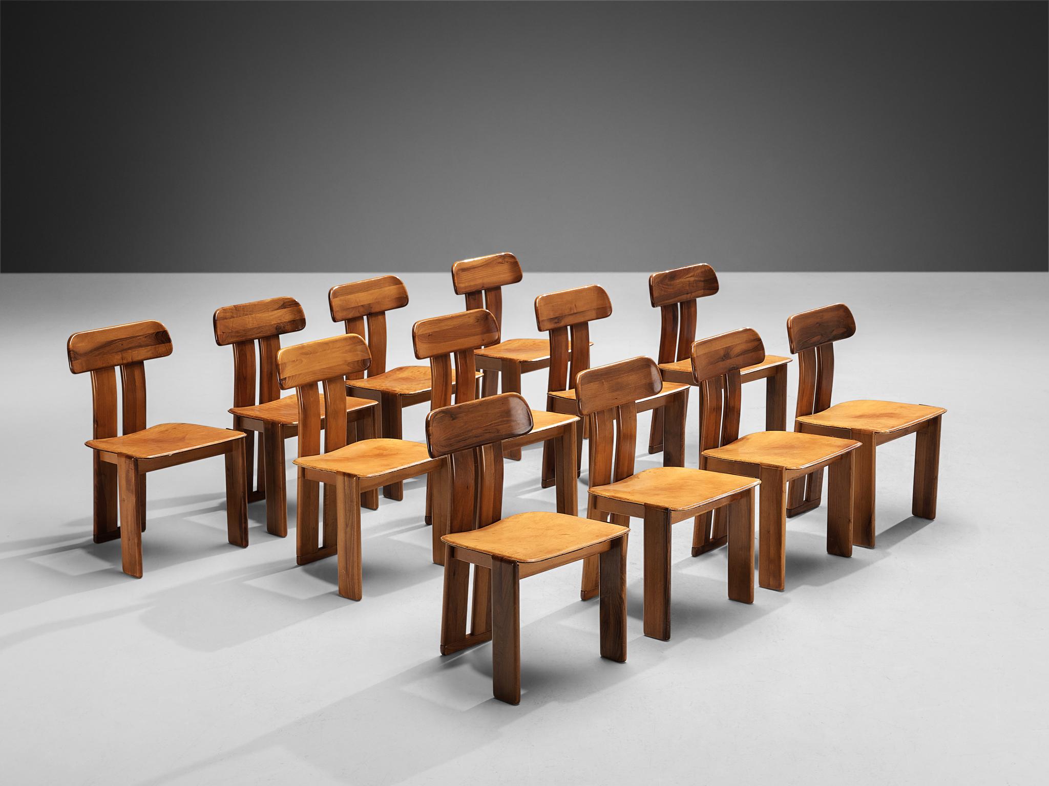 Mario Marenco for Mobil Girgi, set of twelve dining chairs model ‘Sapporo’, walnut, cognac leather, Italy, 1970s

These chairs feature wonderful backrests, consisting of two vertical slats distanced from each other. At the bottom and top these are