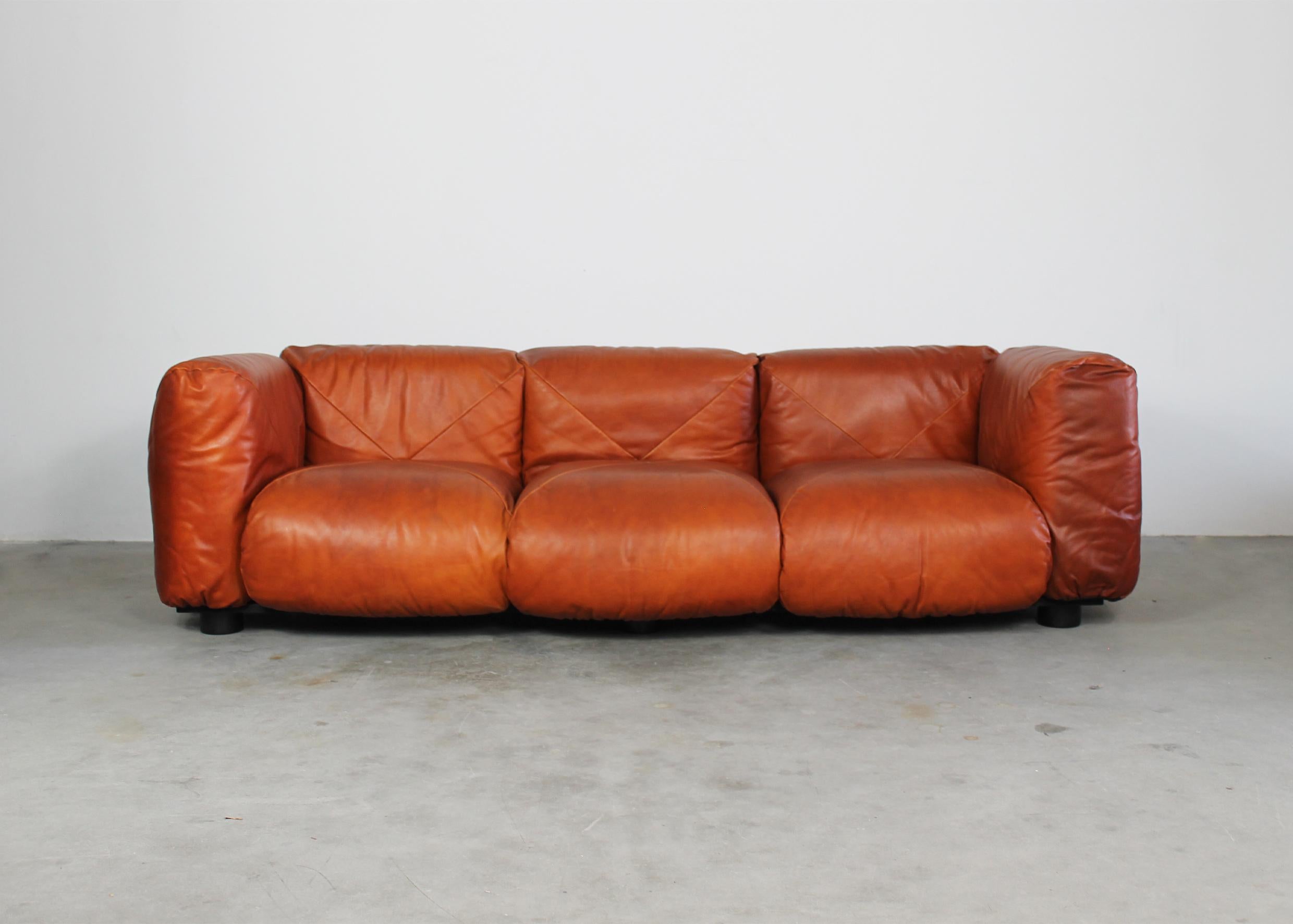 Marius & Marius three-seater sofa with structure in wood and lacquered metal, back, seat and armrests in padded cognac leather. 

Marius&Marius sofa was designed by Mario Marenco, as a part of  the Techniform series, and it was manufactured by