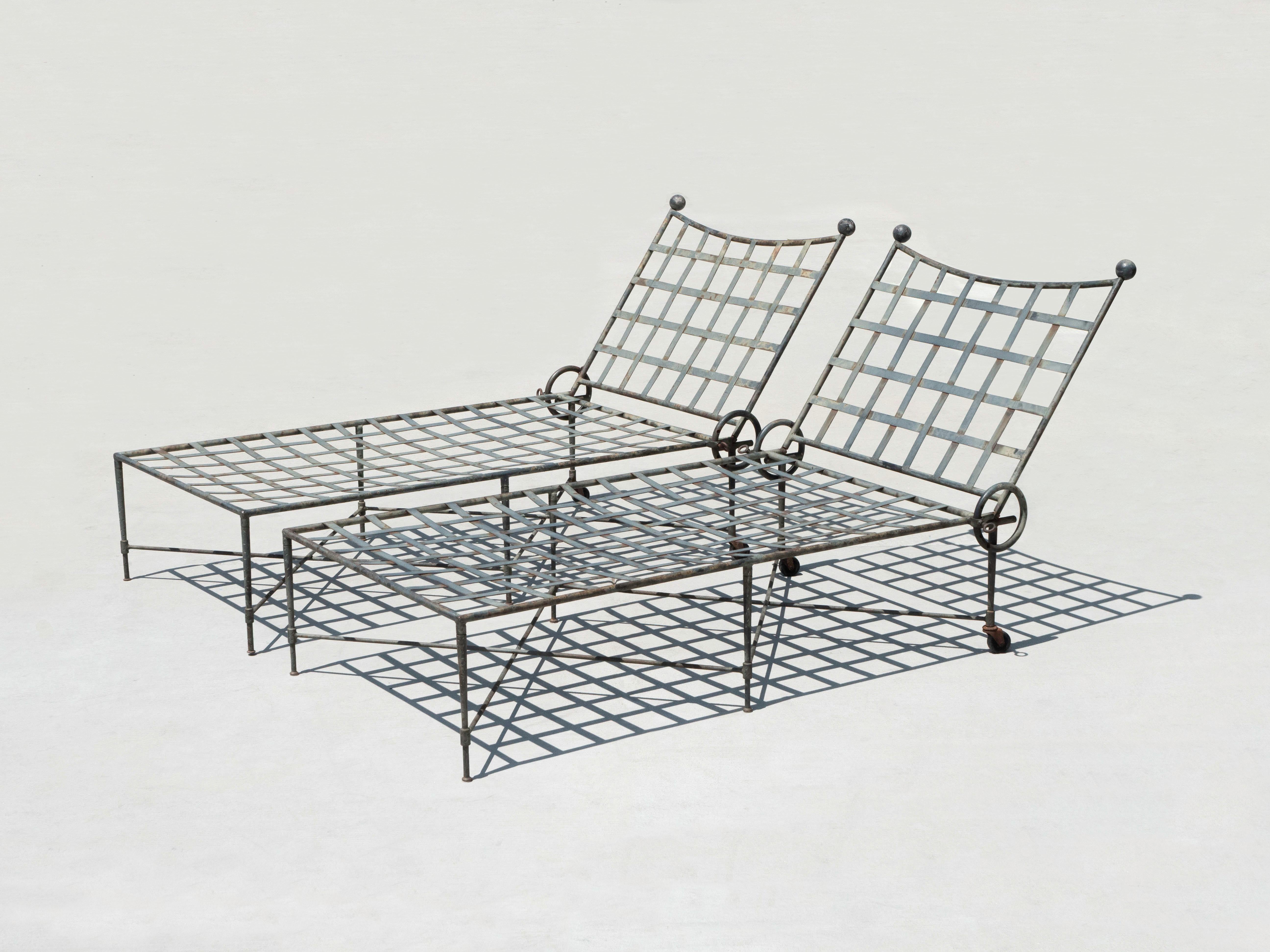 A pair of wrought iron chaise lounge chairs by designer Mario Papperzini for John Salterini.  Manufactured circa 1950's.  This line of furniture was named 