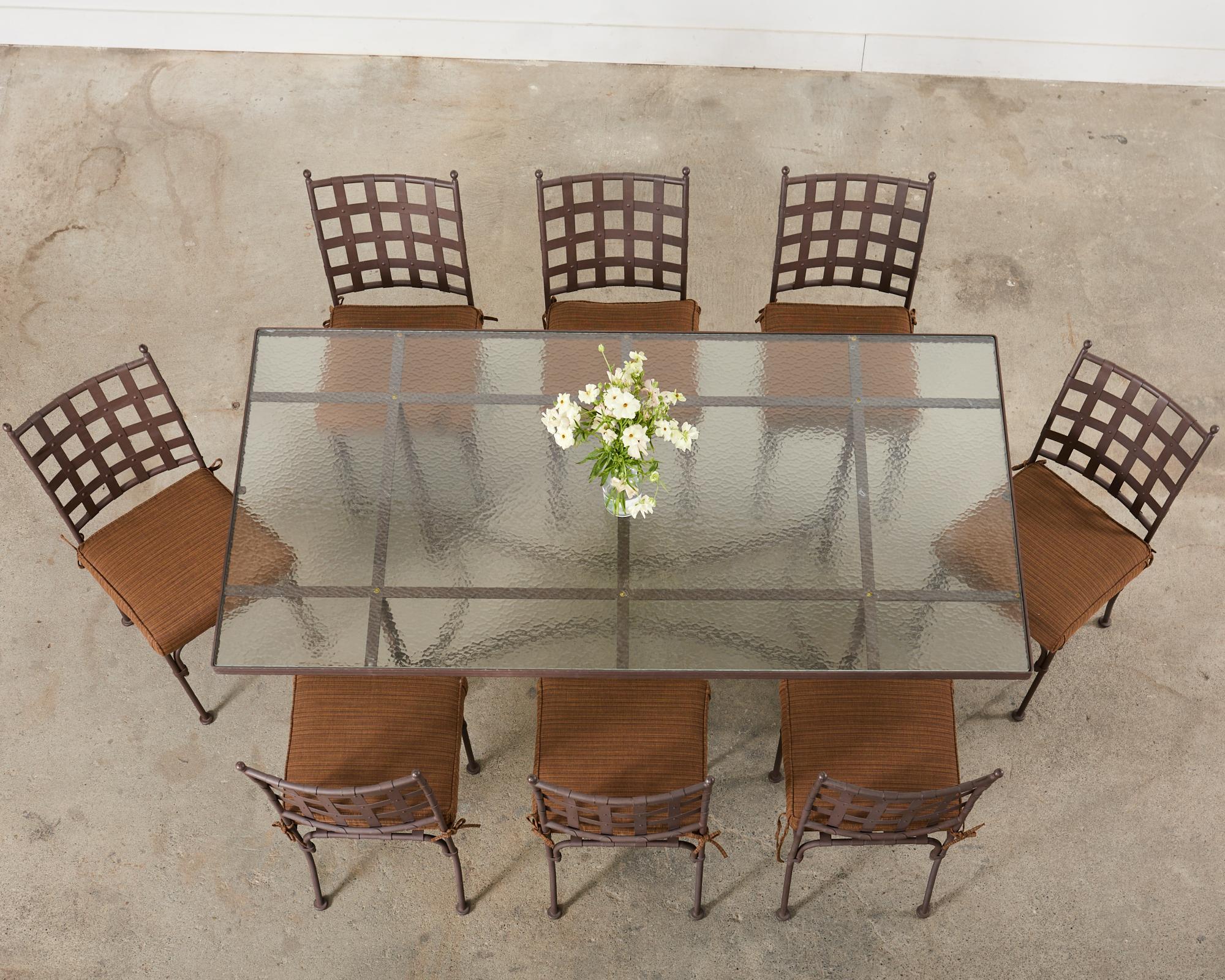 Distinctive patio and garden outdoor dining suite consisting of eight dining chairs and one large rectangular dining table. Beautifully crafted in the manner and style of Mario Papperzini for John Salterini from wrought iron and galvanized steel.