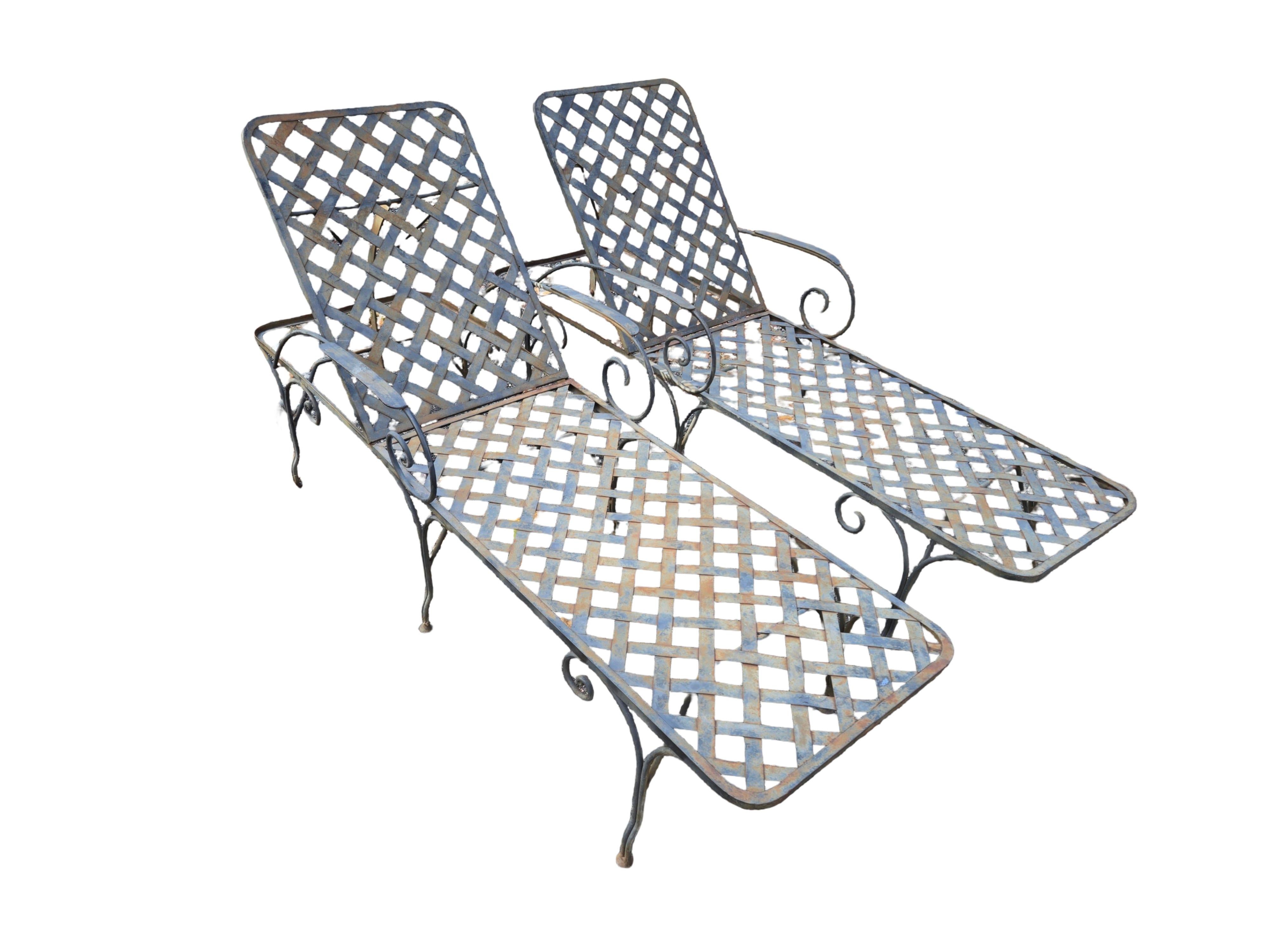 A Pair of adjustable back wrought iron chaise lounge chairs Papperzini style are available now amd ready to ship. Made of heavy duty wrought iron, these chaise lounge chairs will withstand the most severe weather elements and last decades to come.