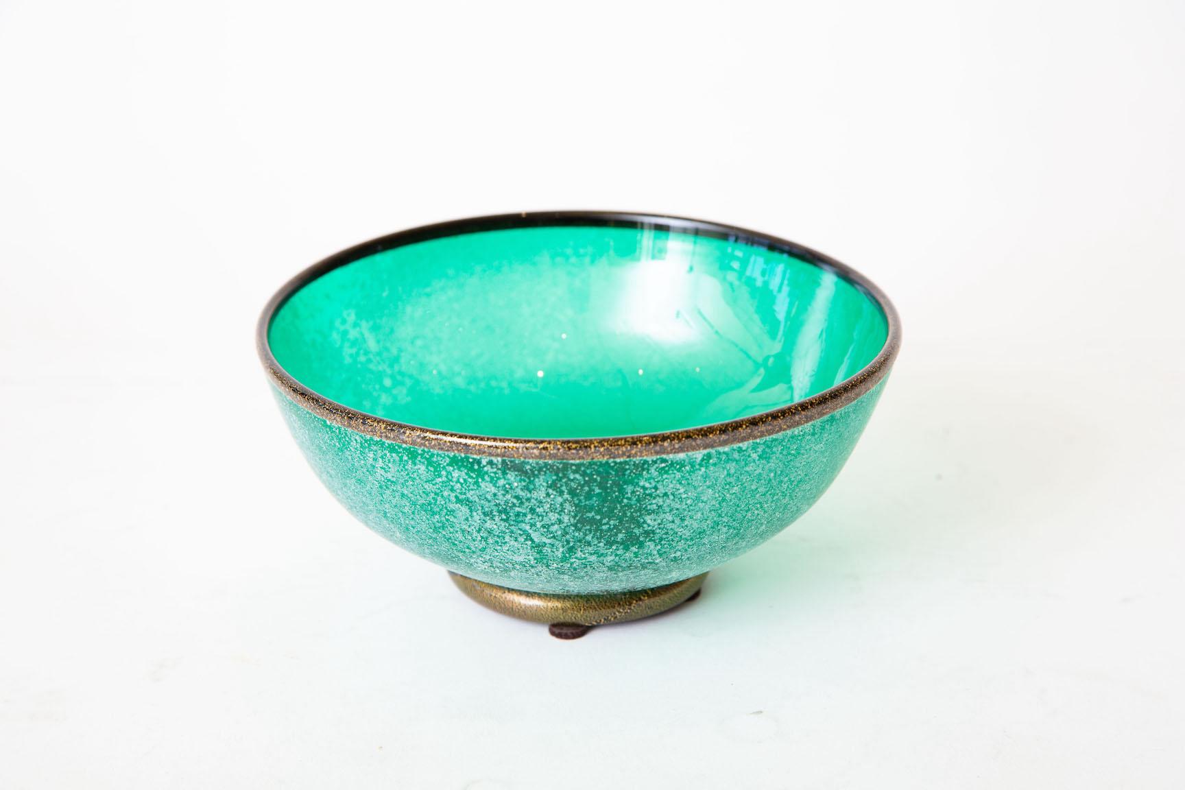 This hallmarked Italian Murano 1980's glass bowl has the scavo technique and is marked Mario Poggi. It is signed on the bottom in script. The partial pair label still exists. The sea green teal turquoise meets emerald green color is beautiful and