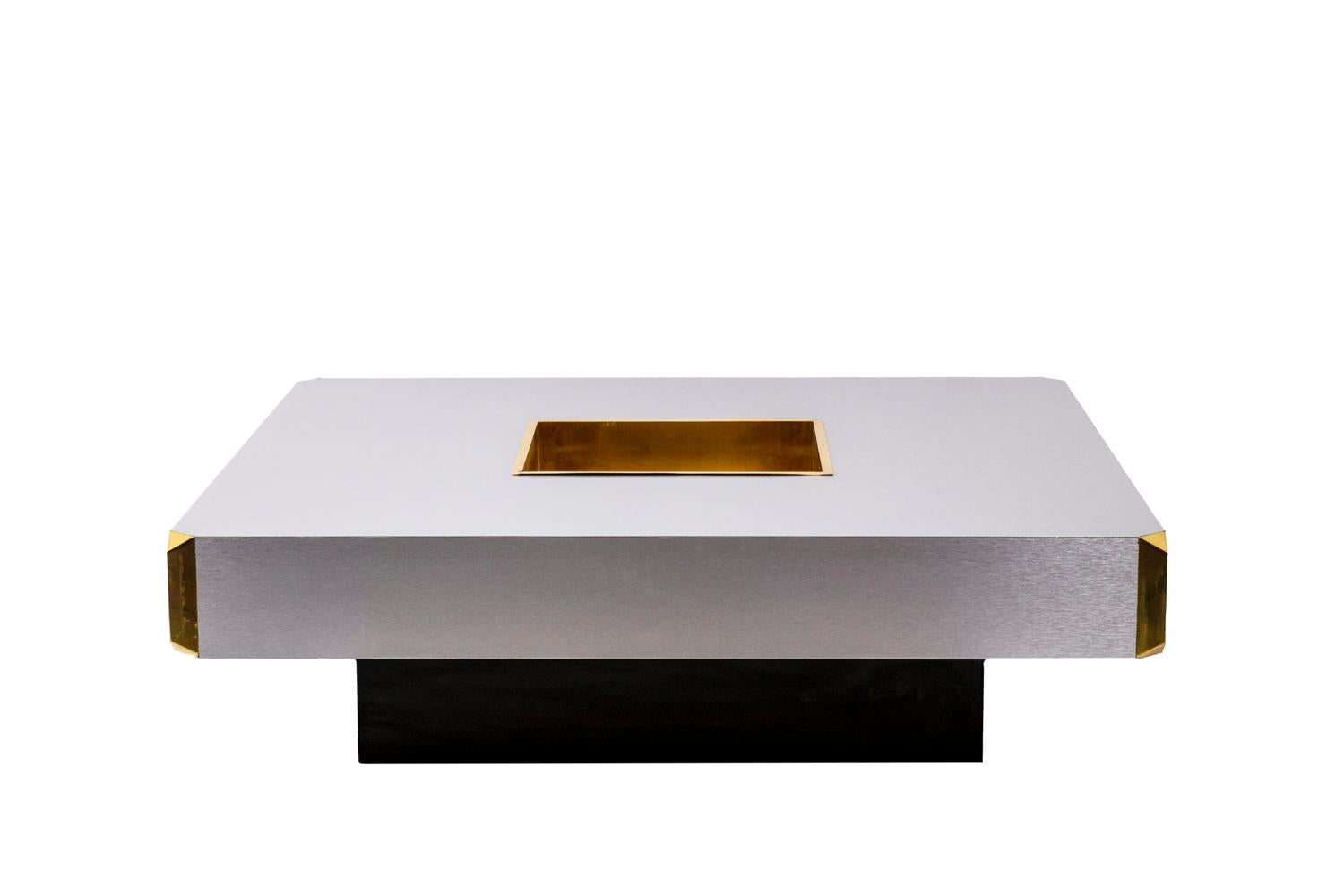 Mario Sabot, edited by.

Coffee table in wood covered by our workshops with brushed aluminum. Hollowed central part. Center of the table and angles in gilded brass. Base painted black.

Work realized in the 1970s.
 