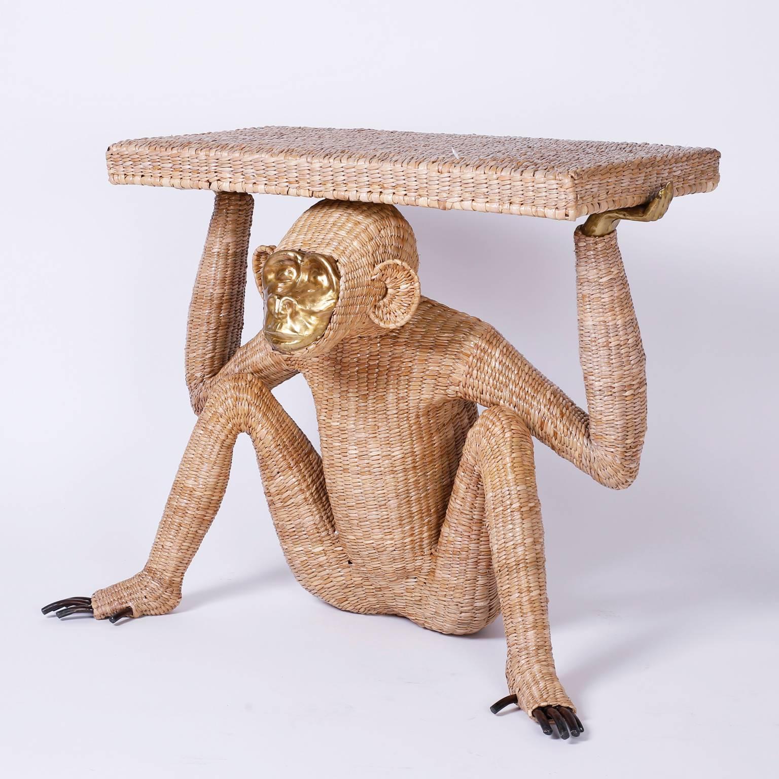 Mario Torres monkey or Chimpanzee console constructed with a metal frame expertly wrapped in wicker or reed. Having a pressed brass face and fingers and exposed toes. Labeled with a brass medallion Mario Lopez Torres 1974. Note that Mr. Torres used