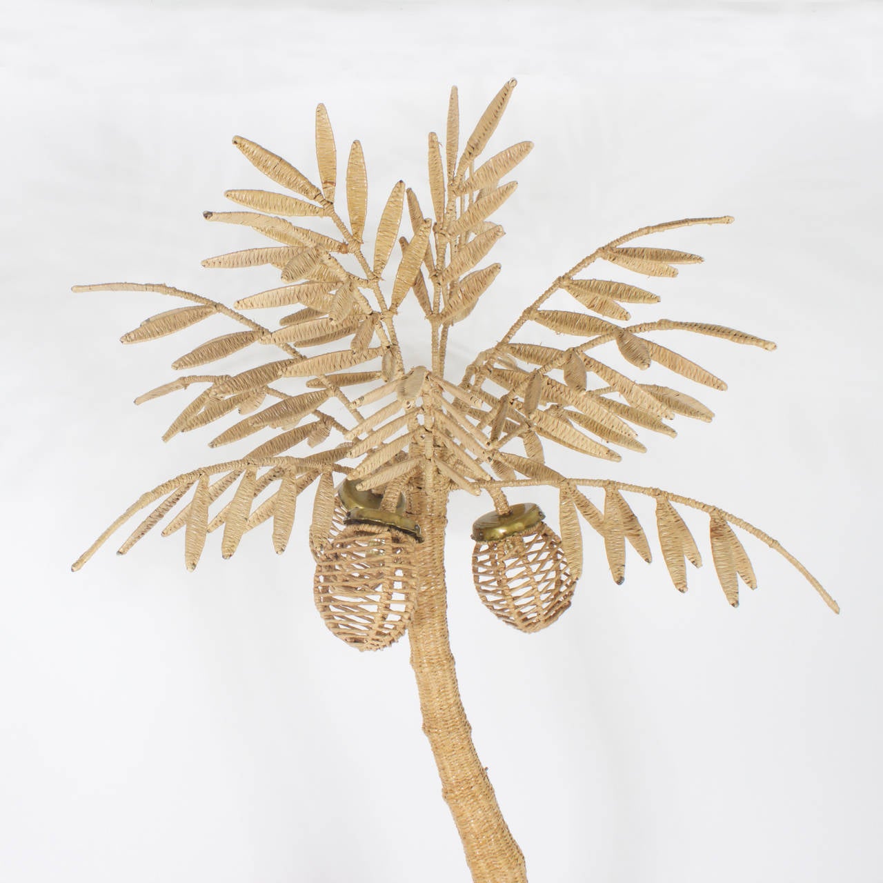 Large Folky Mario Torres palm tree floor lamp constructed of a metal frame wrapped with wicker or reed. 