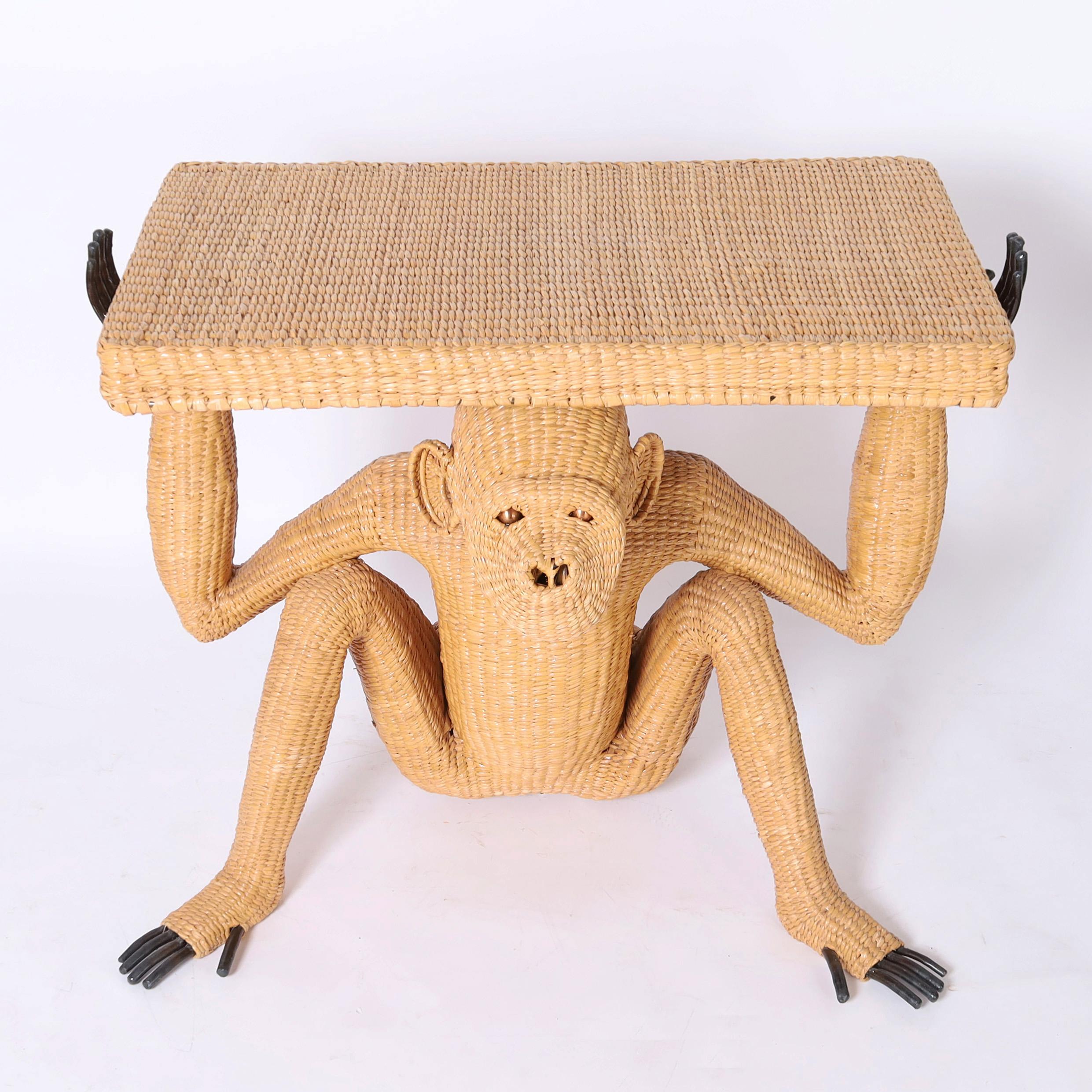 Whimsical vintage console hand crafted in woven reed over a metal frame having a monkey with brass eyes and exposed metal digits supporting a rectangular top. Signed Mario Torres 1974 on a brass medallion. 