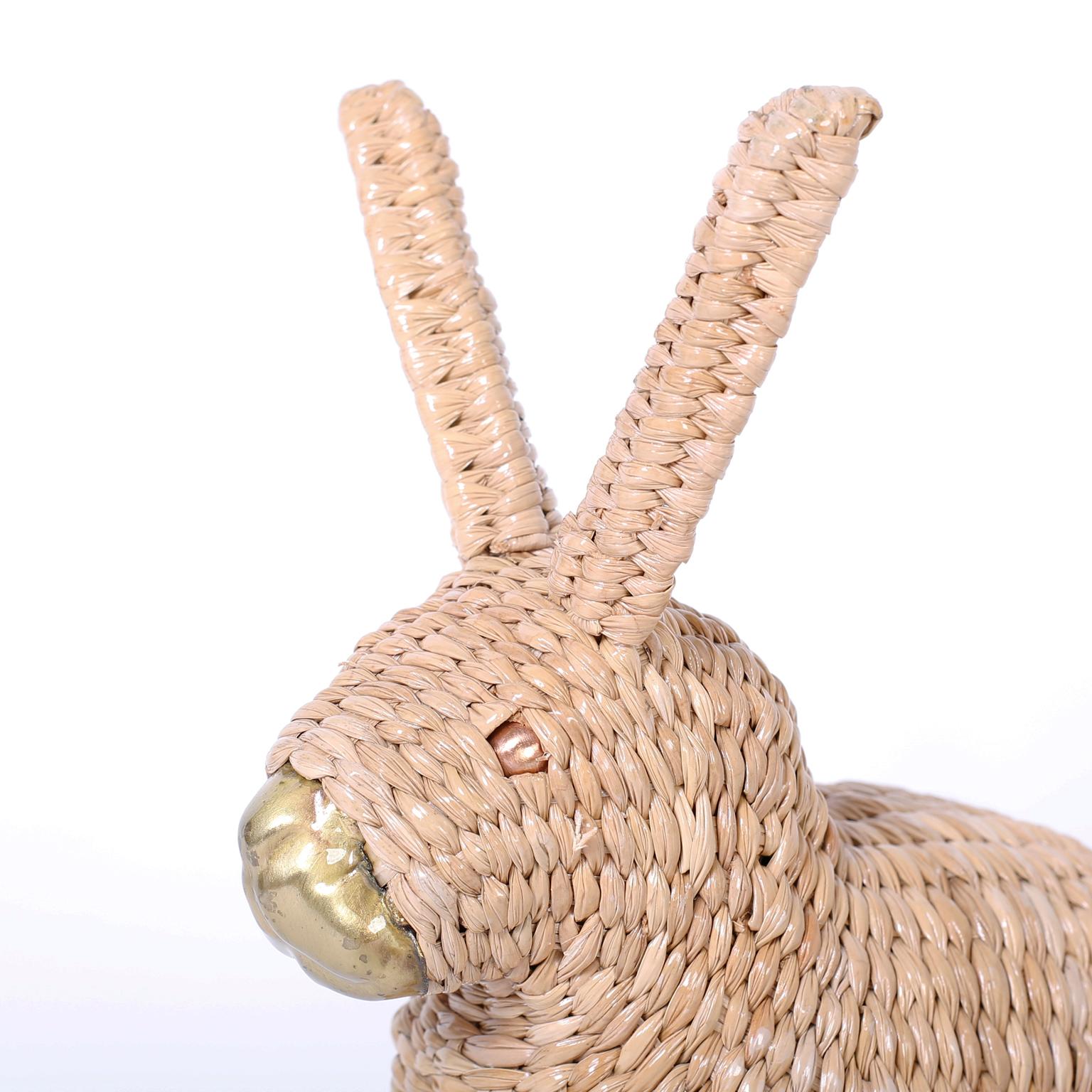 Adorable midcentury bunny or rabbit crafted in wicker, wrapped over a metal frame with a brass nose and copper eyes. Signed Mario Torres 1974 on a medallion.
