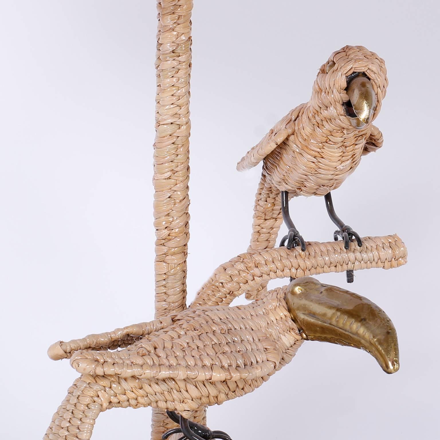 Amusing wicker bird table lamp with a parrot and toucan. Crafted with reed wrapped over a metal frame. Signed Mario Torres on a medallion.
