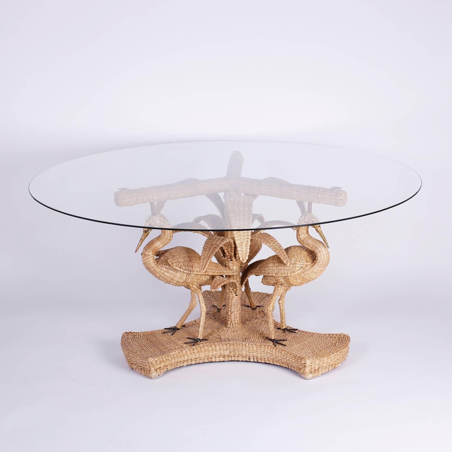 Whimsical wicker or reed table featuring a Palm Tree pedestal and large birds, possible Egrets or Herons with brass eyes, beaks, and feet. The expertly woven rattan reed is tightly wound around a metal form.