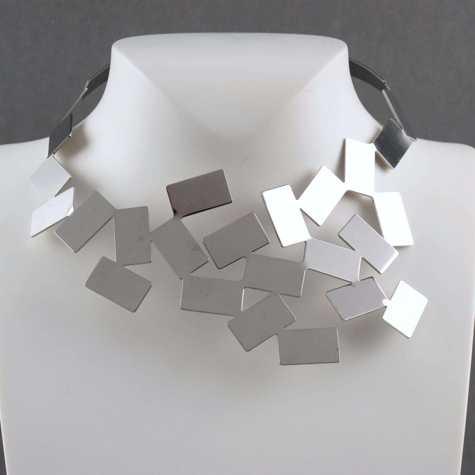 This stunning, modern collar necklace designed by Mario Trimarchi for Alessi is a real statement piece for any formal occasion. In vibrant stainless steel with a polished mirrored surface, the cubic design looks sleek and stylish. Marked at the