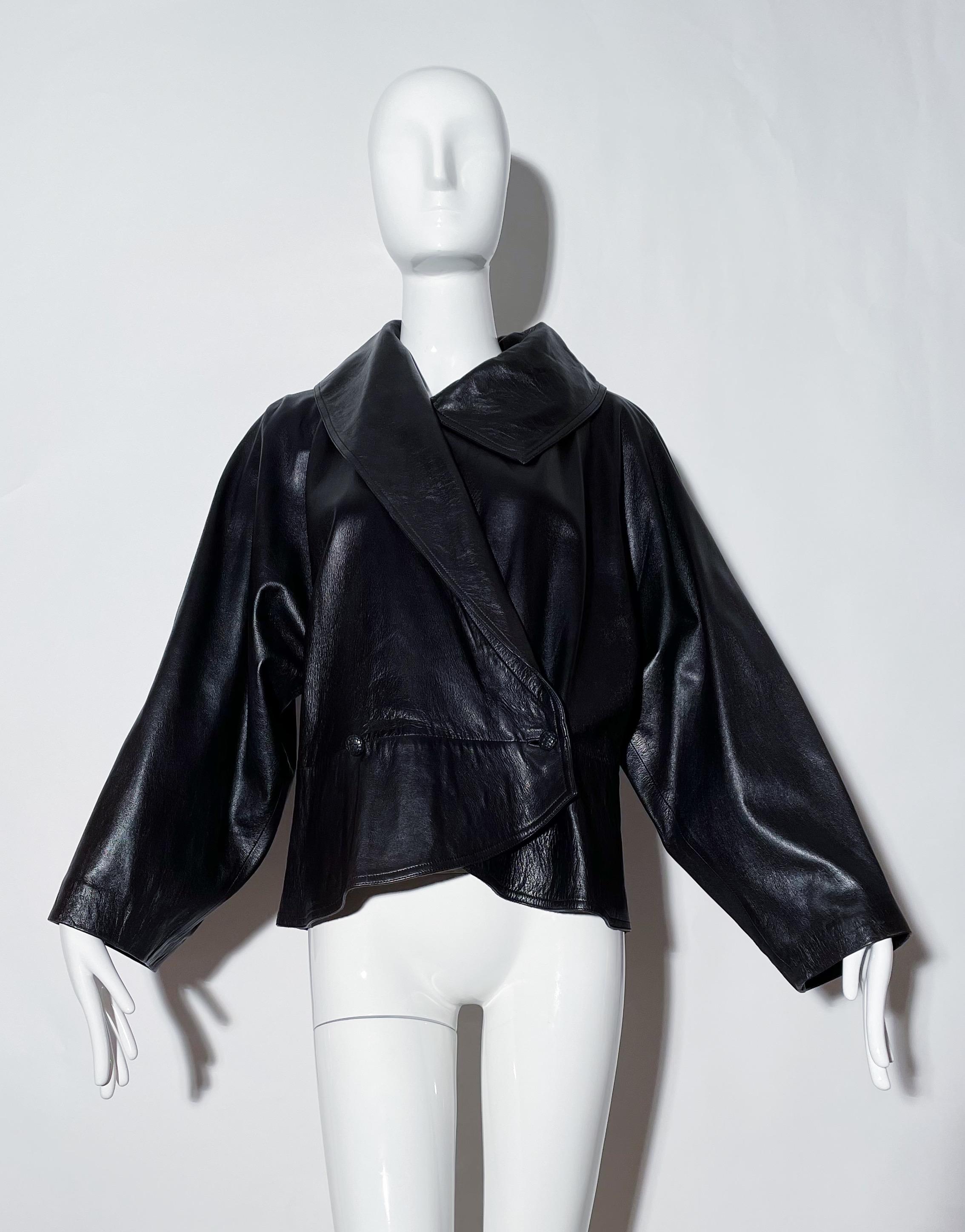 Black leather jacket. Peplum style. Collared. Wide arms. Lined. Leather. Made in Italy. 
*Condition: Great vintage condition. One Flaw along seam on front ( as pictured) 

Measurements Taken Laying Flat (inches)—
Shoulder to Shoulder: 17 in.
Sleeve