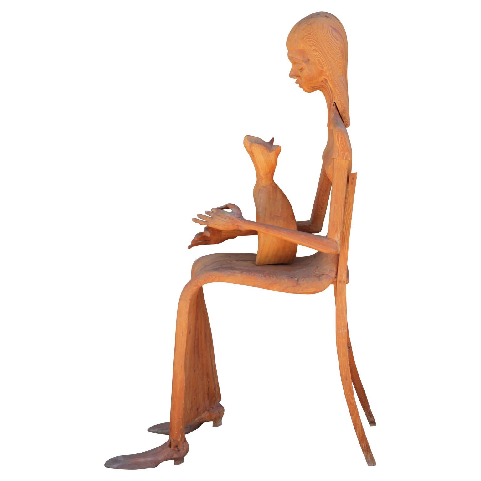 Modern Hand Carved Wooden Folk Sculpture of a Seated Woman with a Pet Cat  - Brown Figurative Sculpture by Marion Perkins