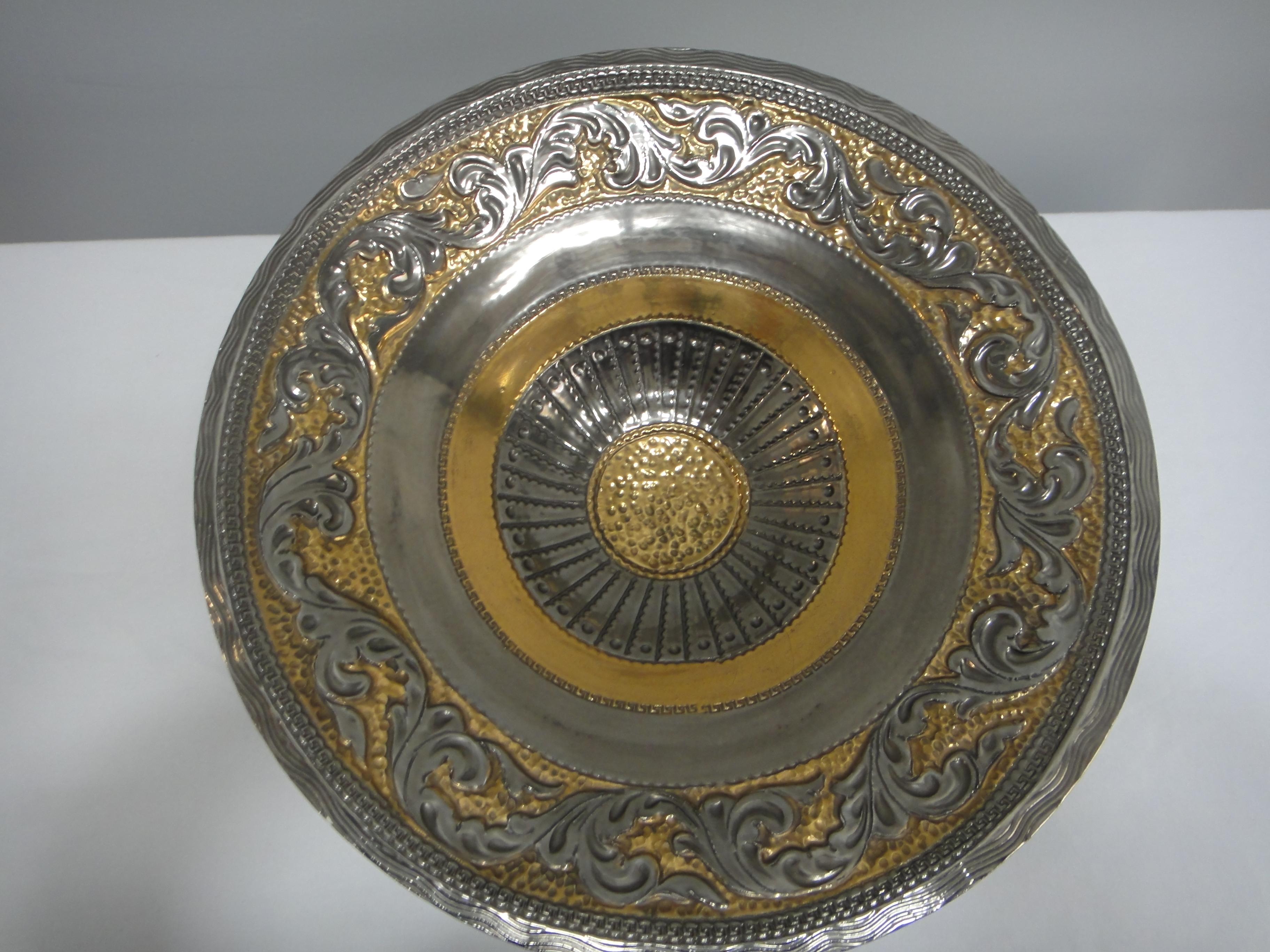 Offered for sale is a striking glazed ceramic centerpiece bowl created in the neoclassical style by Marioni of Italy. The bowl is created to appear as though it is metal.