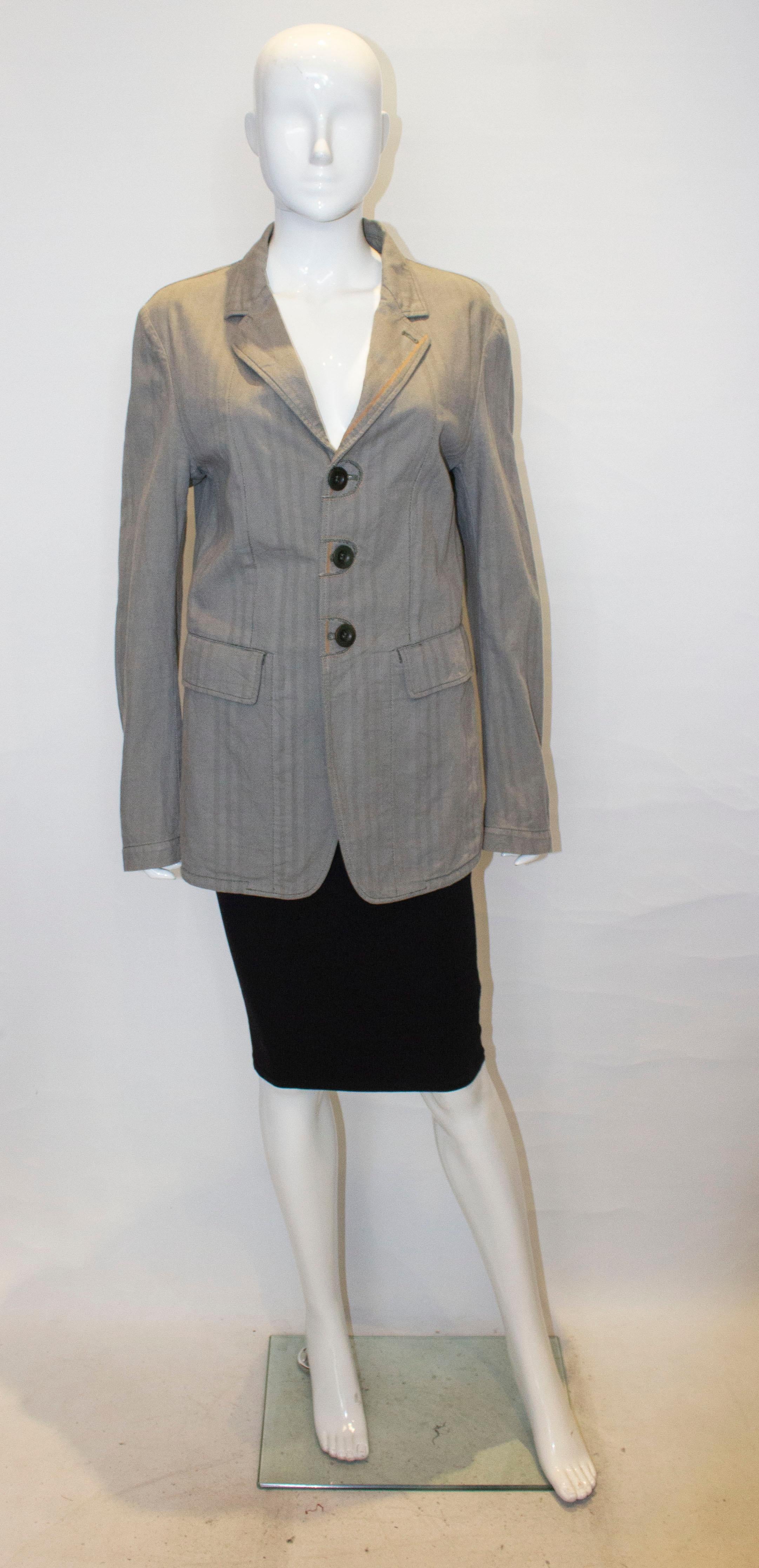 A chic cotton jacket by Marithe Francois Girbaud.  The jacket is in an interesting mix pattern fabric. It is unlined, with  three button front opening, two large pockets on the front, a one button cuff and 7 '' slit at the back. 