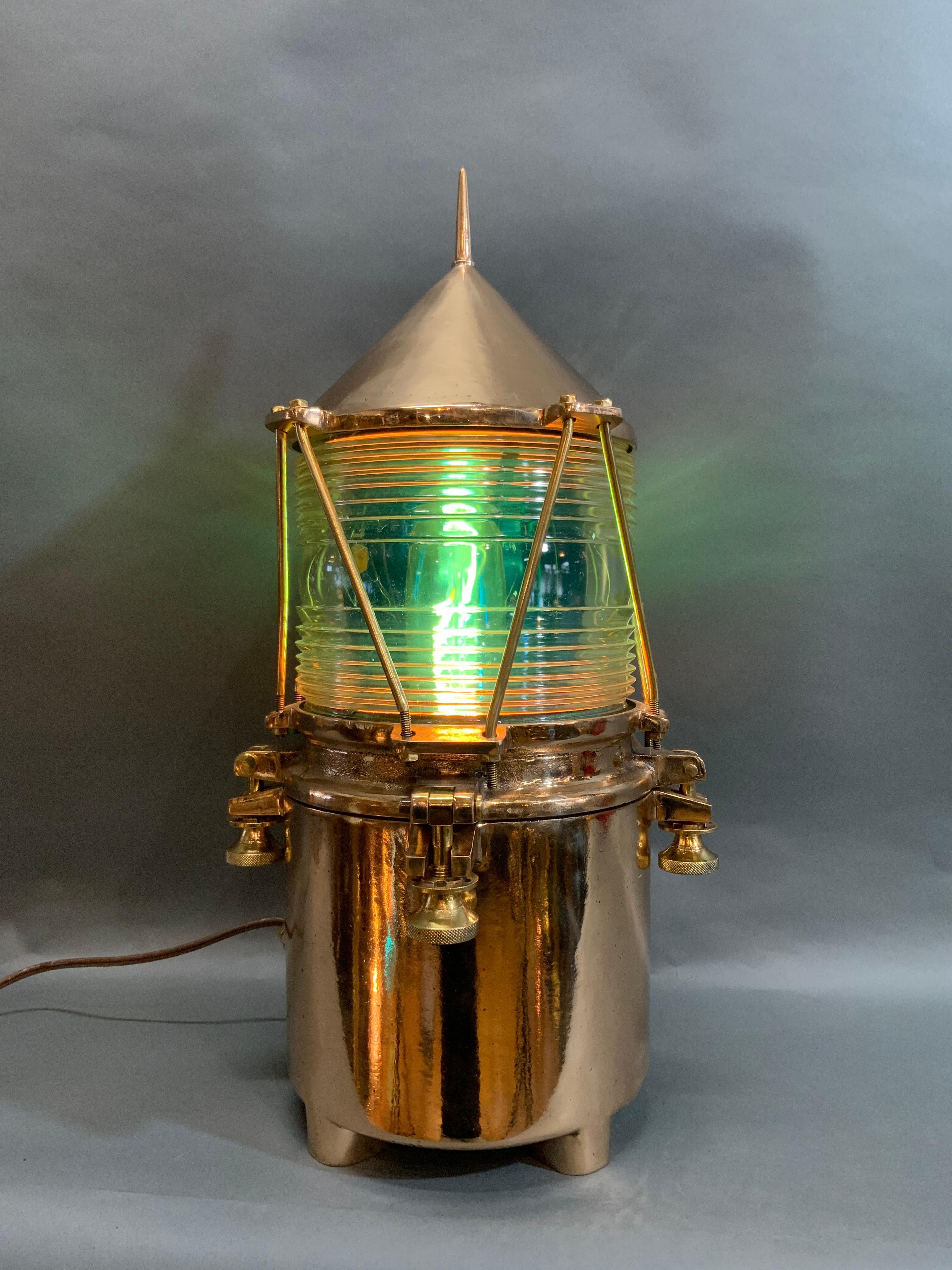 Maritime beacon of solid brass with thick glass Fresnel lens. Meticulously polished and lacquered. Rare design with spiked top, protective bars, and flanged feet. Wired with electricity for home use.

Overall dimensions: 24