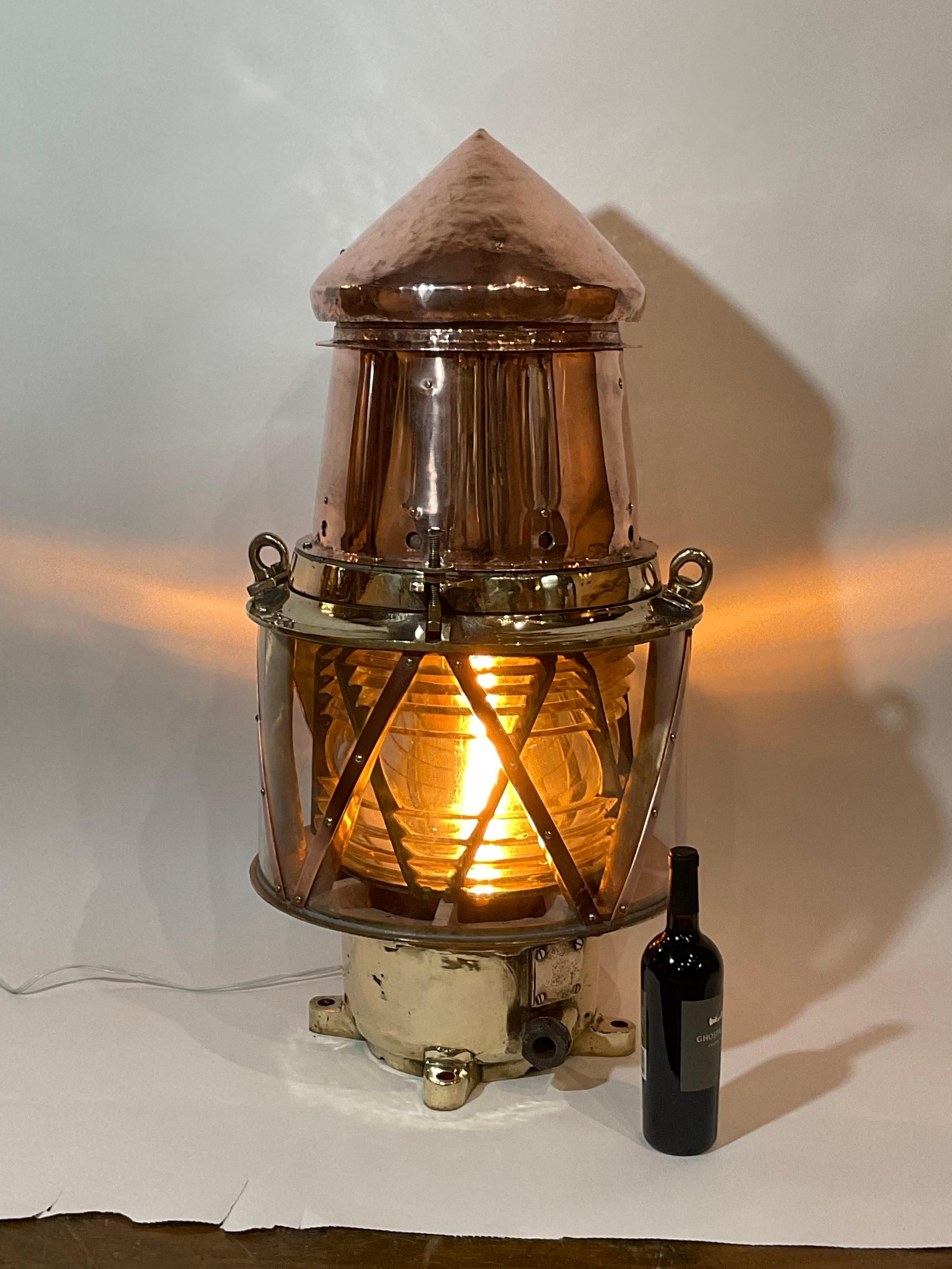 Copper buoy light with bronze frame Fresnel lens. Hinged top with brass hinges and bezel. Built to the highest quality to withstand decades at sea. Professionally polished. Fitted with AC sockets.

Weight: 50 lbs.
Overall Dimensions:
Made: